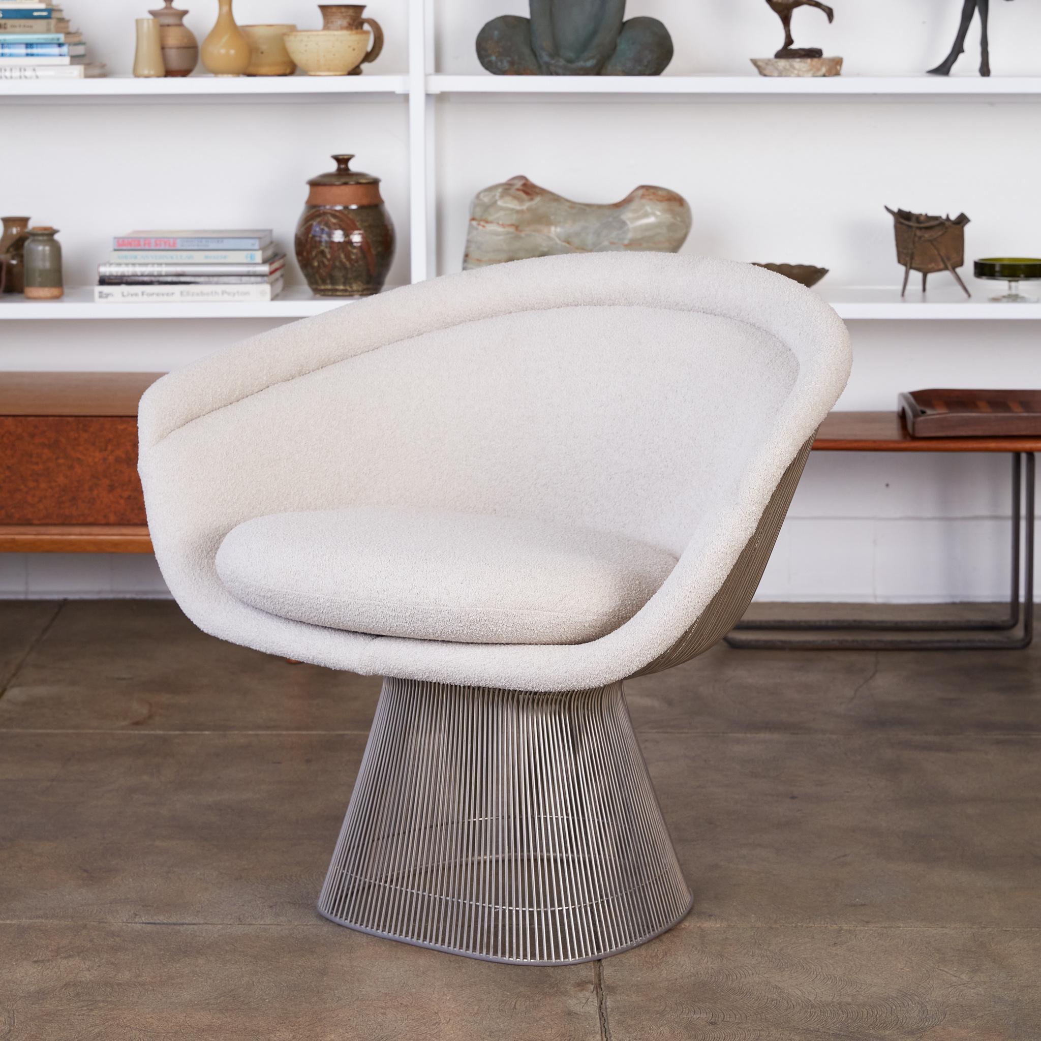 An intricately minimal armchair by Warren Platner for Knoll. Designed in 1966, the Platner collection featured designs defined by curved and welded steel spokes. The chair has an hourglass shape with seat, and back cushions in an light gray bouclé