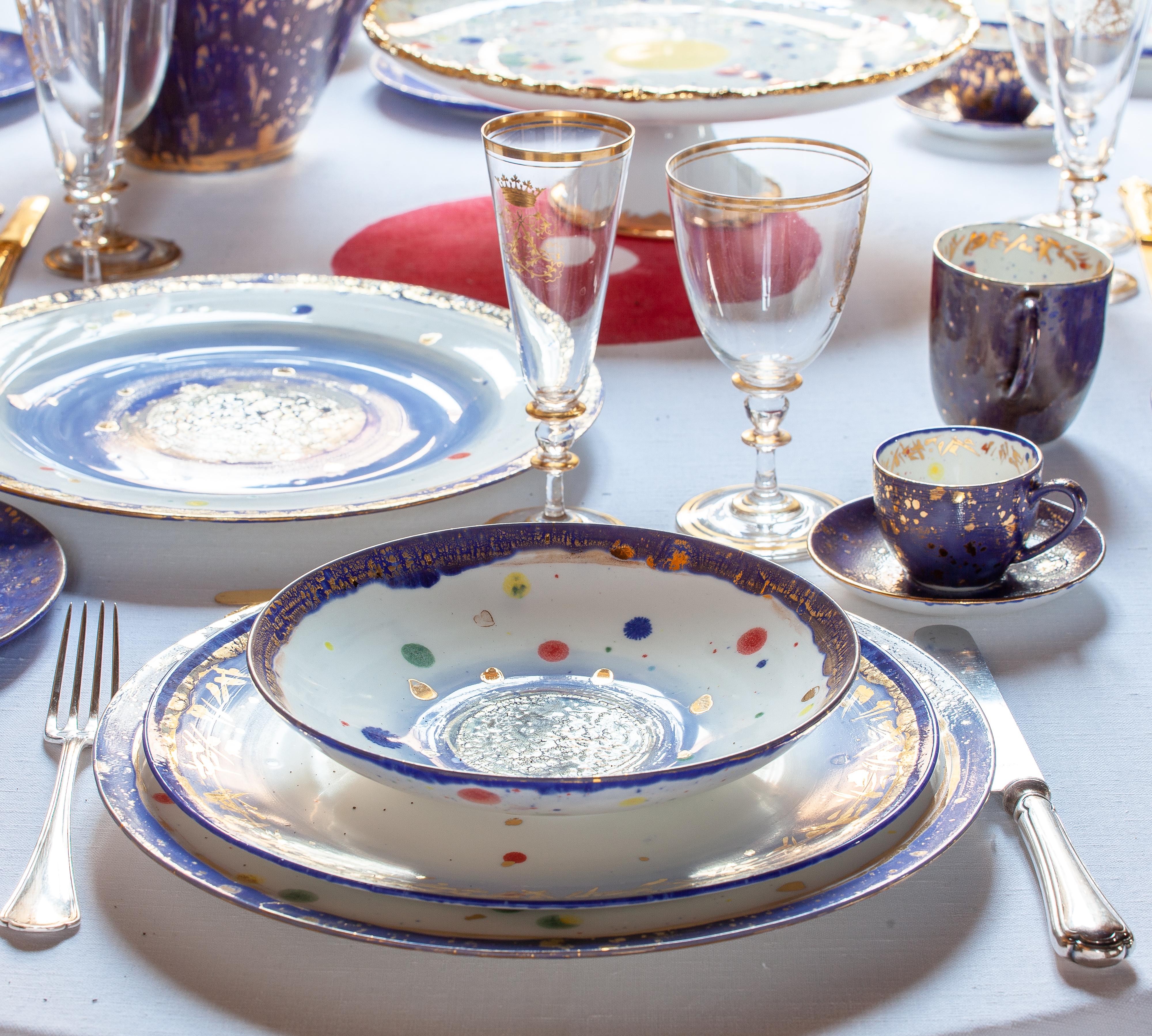 Handcrafted in Italy from the finest porcelain, this Apollo Bianco Platter leads us into a magic world. Shades of blue lapis lazuli evoke the magic of oriental novellas. A fairytale is revealed by playful nuggets of gold, green red and blue drifting