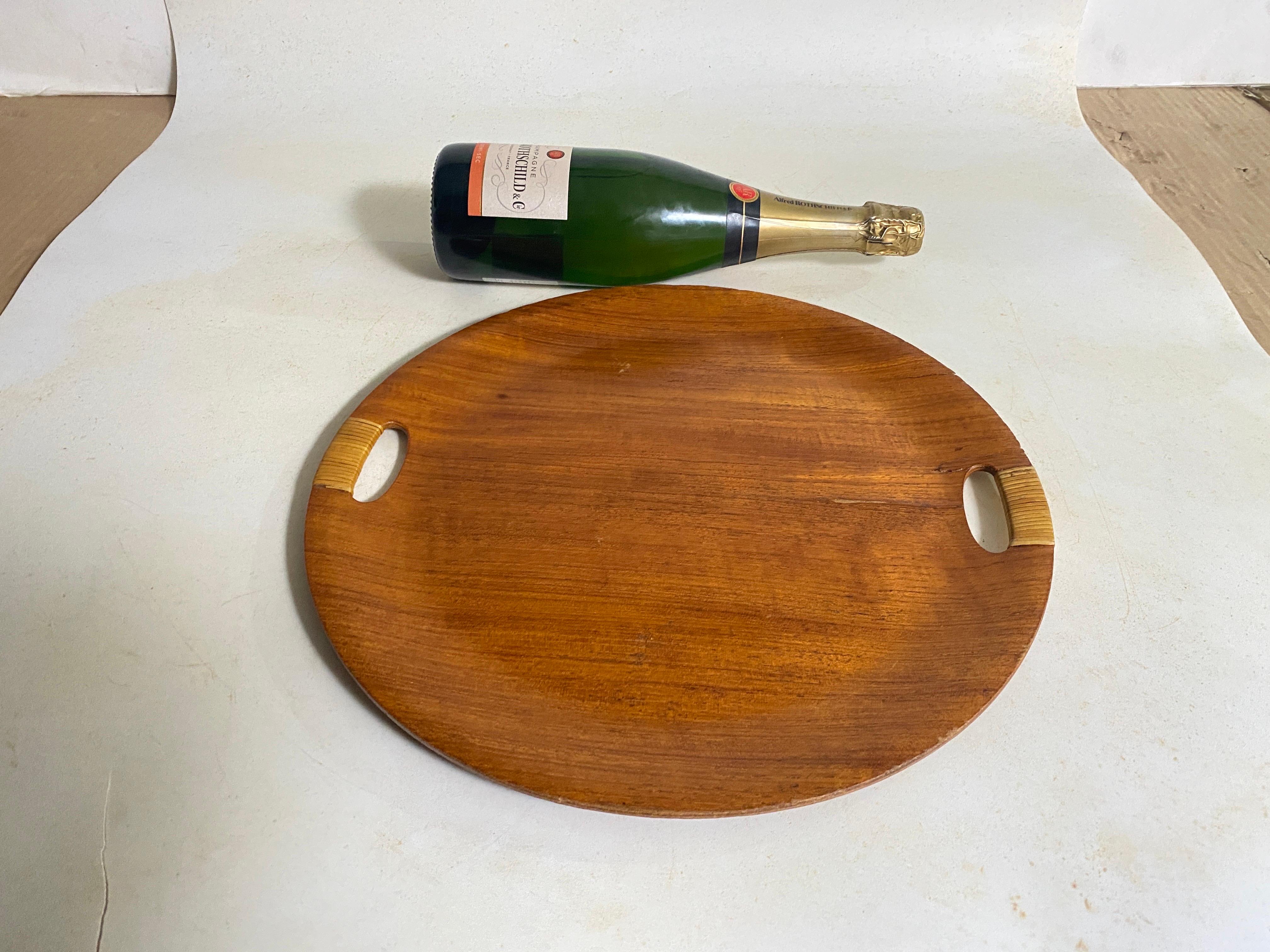 This tray or platter is from Denmark. It has been made in the 1960s.
Brown Color.
Round shape.
Rattan and Wood.
