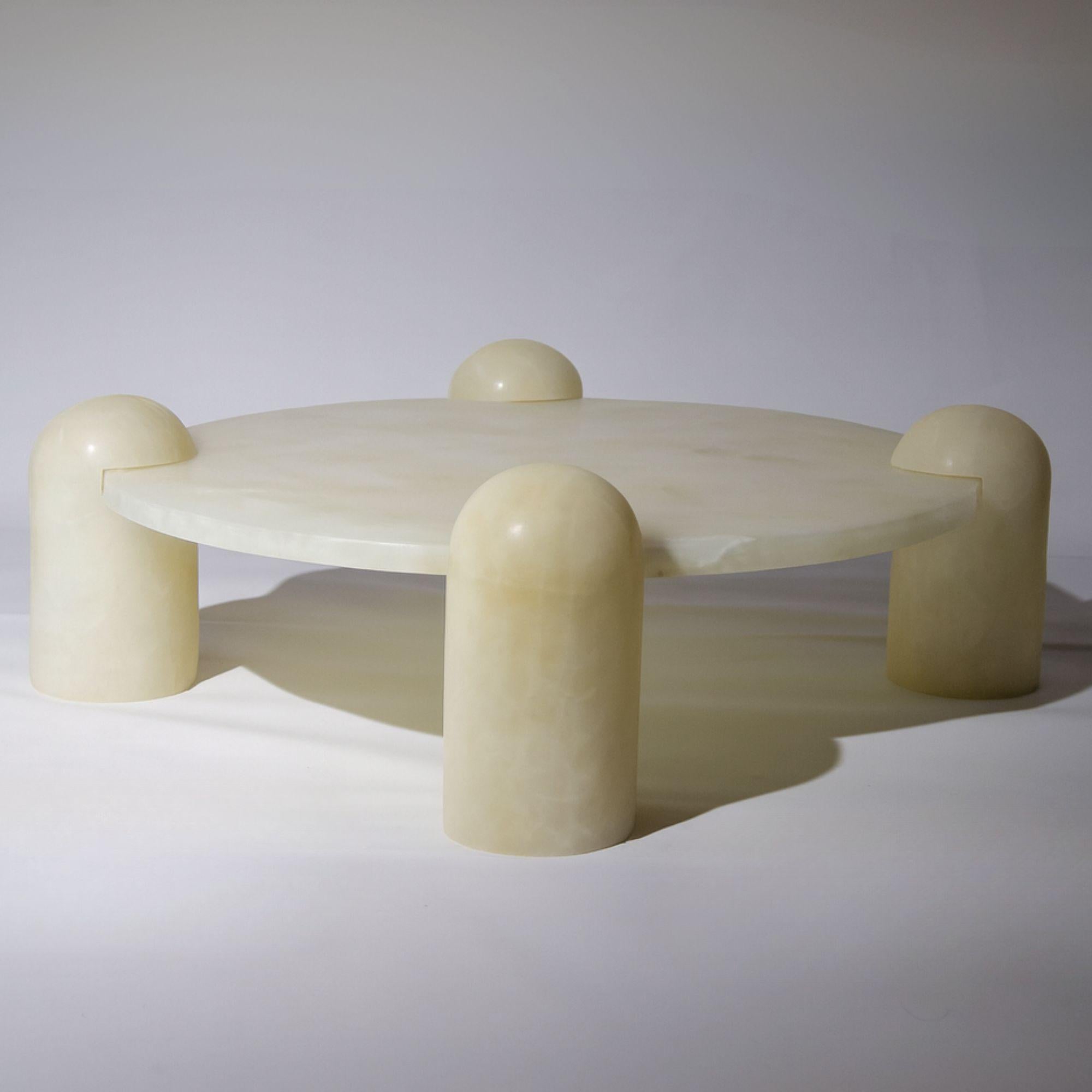 Rounded pillars of white Mexican onyx carry a white marble top to create  Play-time Table; An elegant rendition of children’s furniture. A piece meticulously hand-sculpted from stones endemic to Mexico. The combination of materials, which reign over