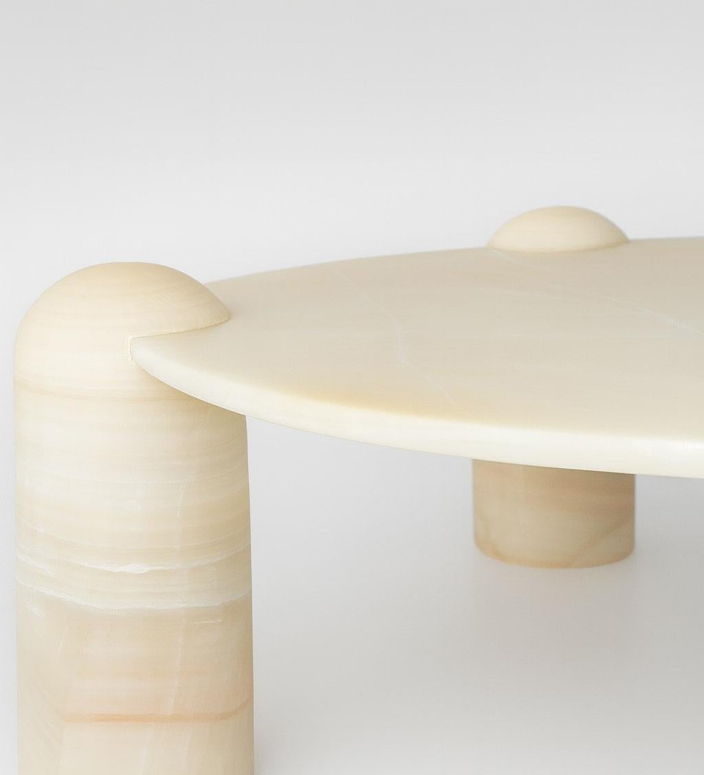 Rounded pillars of white Mexican onyx carry a white marble top to create  Play-time Table; An elegant rendition of children’s furniture. A piece meticulously hand-sculpted from stones endemic to Mexico. The combination of materials, which reign over