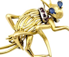 Playful 14 Karat Yellow Gold Cricket Brooch with Sapphire and Ruby Accents