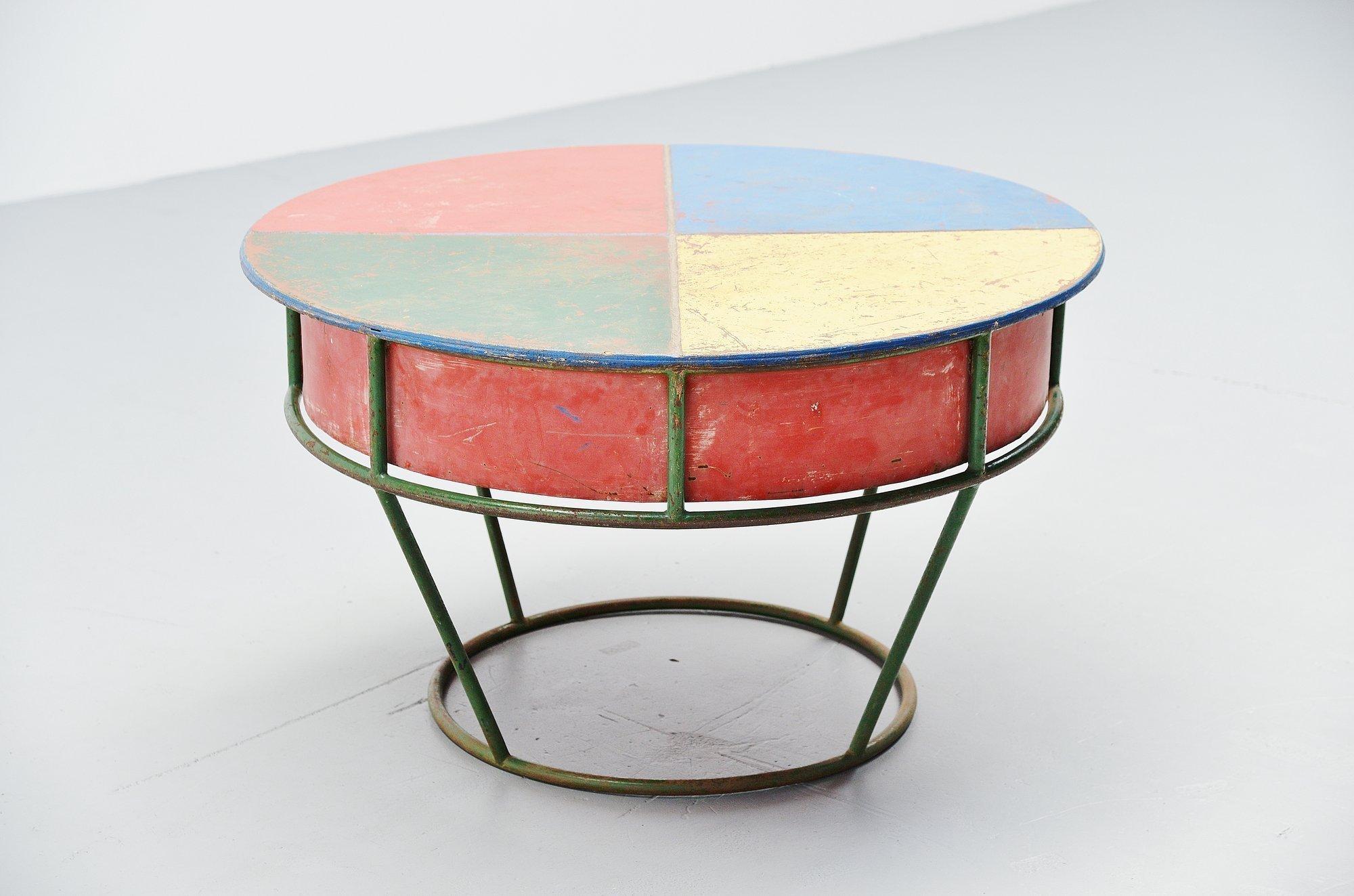 Very nice and decorative playful garden table, France, 1950. This very nice and characteristic piece has an amazing patina from age and usage. This colorful table has a removable top and you can put sand or water underneath it. Very nice piece for