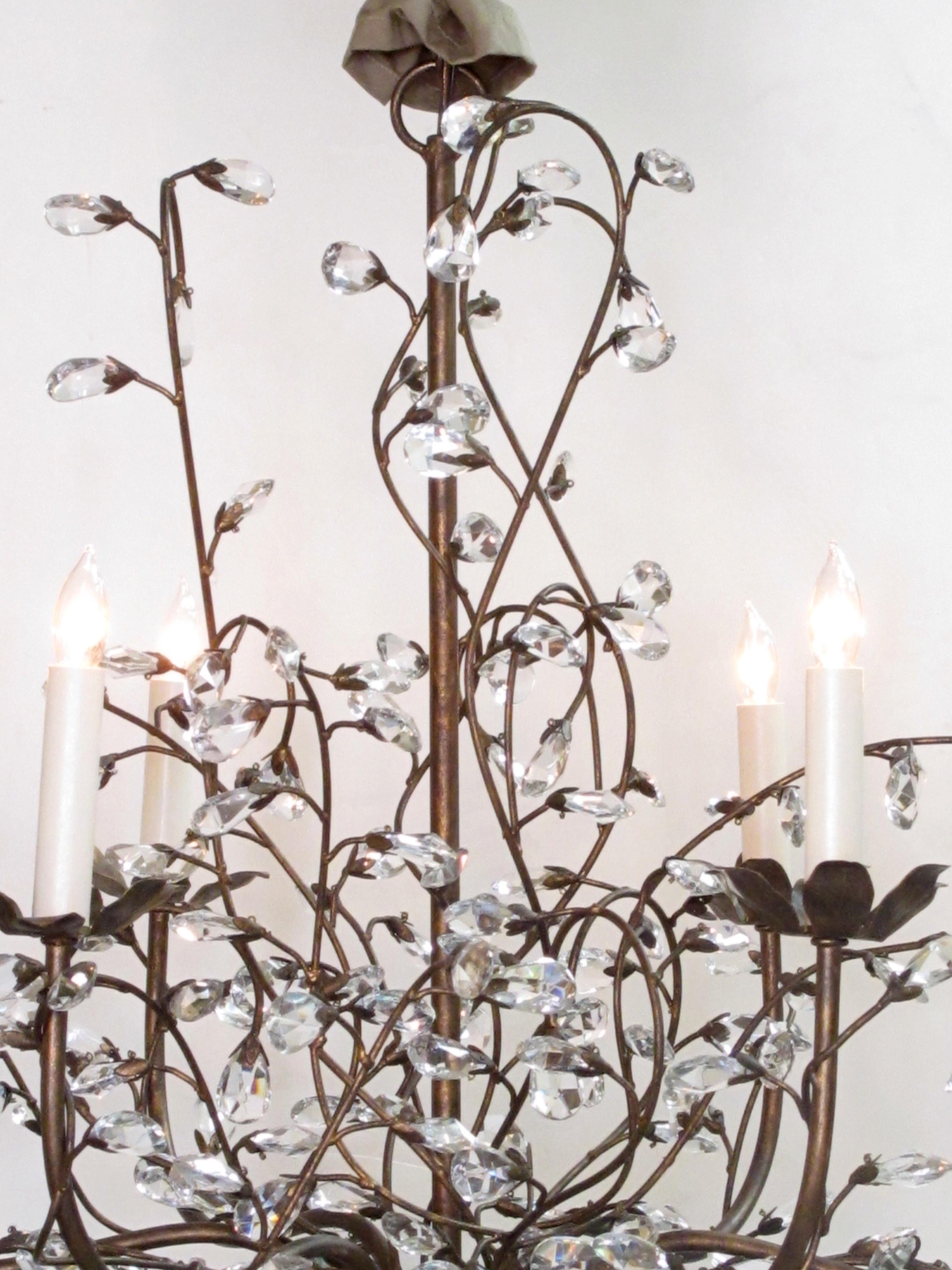 A playful Italian 1970s bronze lacquered metal six-arm chandelier adorned with crystal foliate tendrils; the central shaft emanating six bronze lacquered metal candle arms interspersed with meandering vines ending with crystal petals, excellent