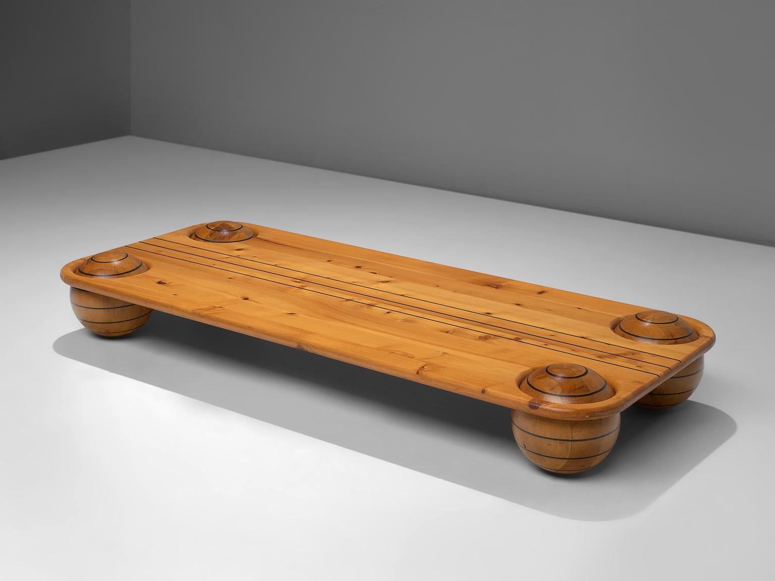 Coffee table, pine, Italy, 1970s.

This playful coffee table from Italy shows minimalism in a fun way. The tables consist of four wooden spheres with black stripes. A tabletop in pine with four holes is placed on top of the spheres, which create a