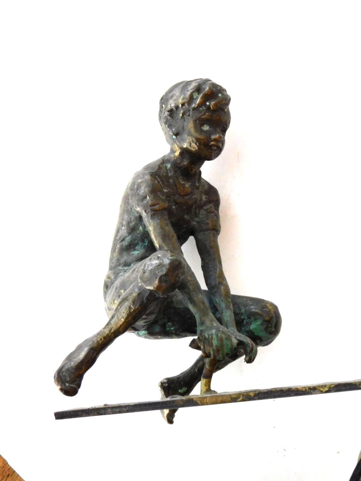 Well-executed solid bronze sculpture of young boys on a seesaw; all resting on a solid onyx base; Curtis Jere was a metalwork company of wall sculptures and household accessories founded in 1963. Elle Decor referred to the works of Jere as 'vintage