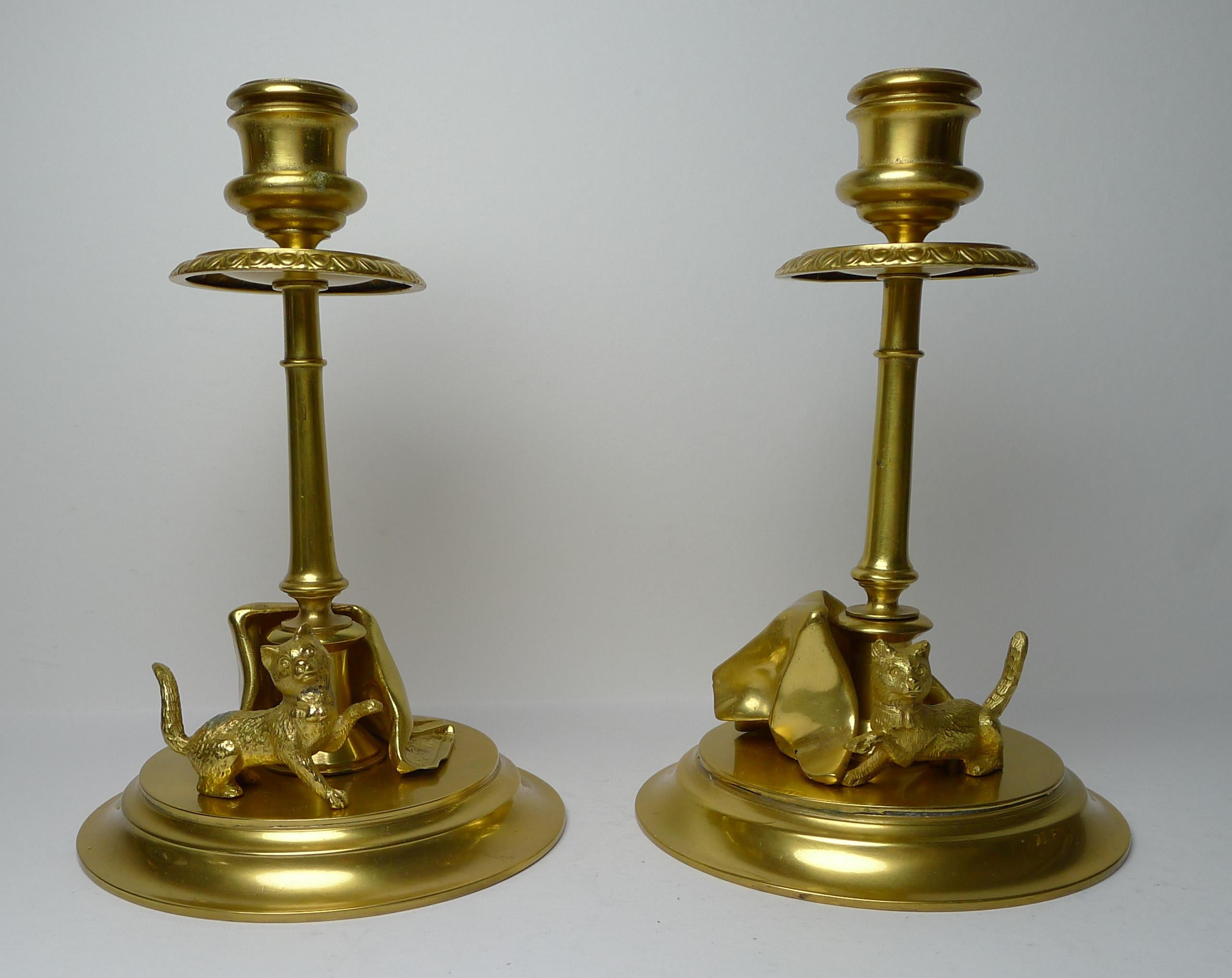 A rare and magnificent English desk set made from gilded bronze in superb condition. The set consists of a pair of candlesticks, a pen tray, an inkwell, a seal and a letter opener.

All pieces feature cast cats or kittens playing with rugs and