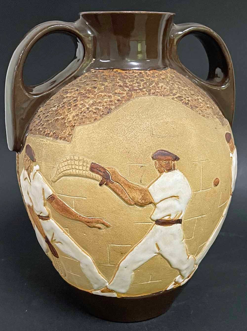 Rare and exceptional, this Art Deco vase produced by Poterie De Ciboure in southern France celebrates the regional sport of pelota (or pelote), featuring six players in their handsome white shirts and pants.  Each of the men is shown with a