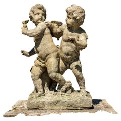 Niños angelitos jugando, fundición en piedra, probablemente de finales del siglo XX