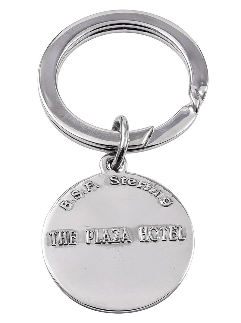 A special keepsake:  a key ring, with an applied depiction of The Plaza Hotel.  On the reverse side, applied letters spell out 