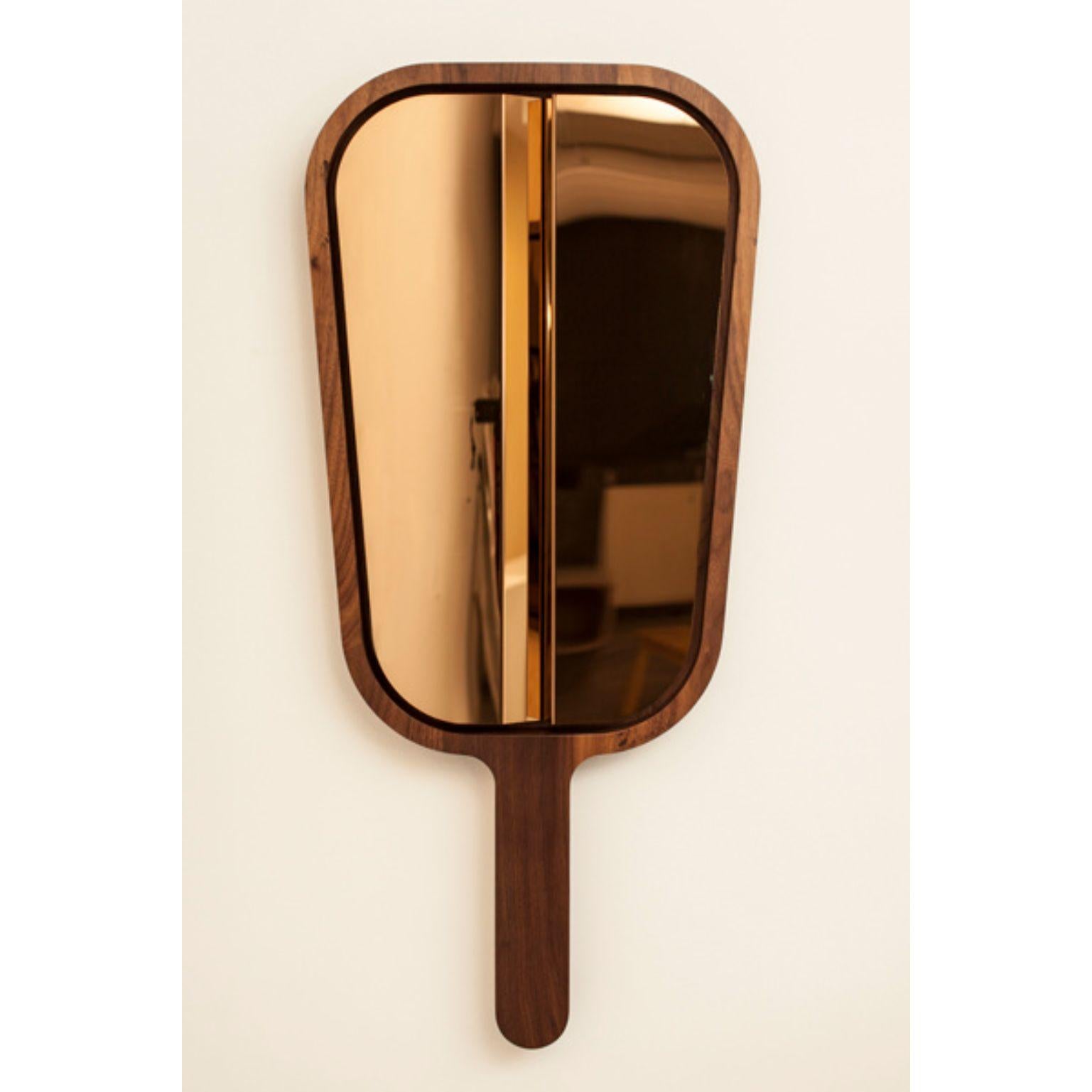 Please Don't Tell Mom mirror 2 by Marc Dibeh
2015
Materials: American walnut, polished stainless steel, rose gold finish
Dimensions: W 48 x H 90 x D 4 cm 

This happy accident, caused by coincidently breaking a mirror during an experiment, lead