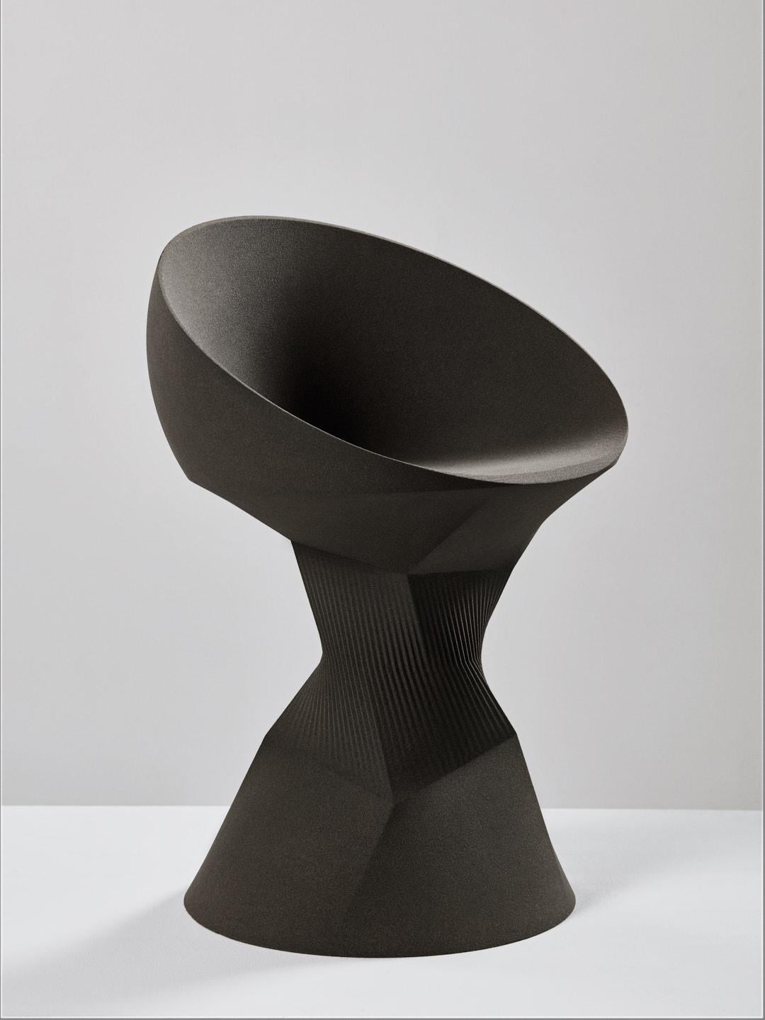 The pleat chair is part of the 'Sand in Motion' collection – a family of sculptural objects manufactured from 3D printed sand, using technology that was developed for the German automotive and aerospace industries. 

The chair is designed primarily