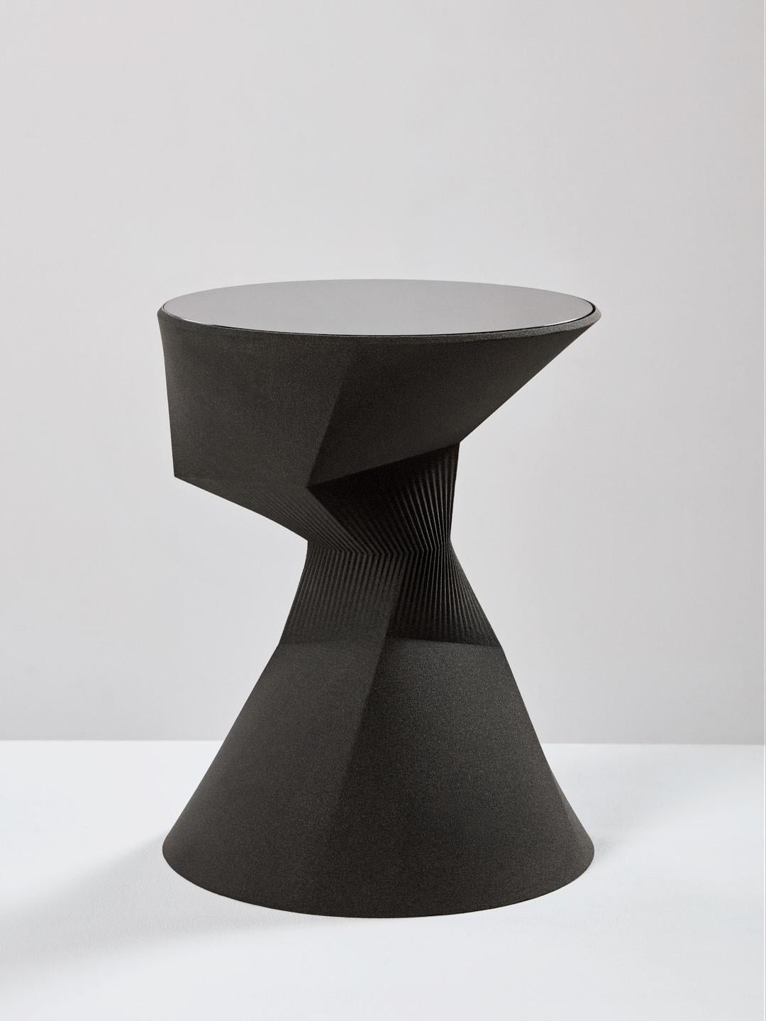 The pleat table high is part of the 'Sand in Motion' collection – a family of sculptural objects manufactured from 3D printed sand, using technology that was developed for the German automotive and aerospace industries. 

The subtle curves, in