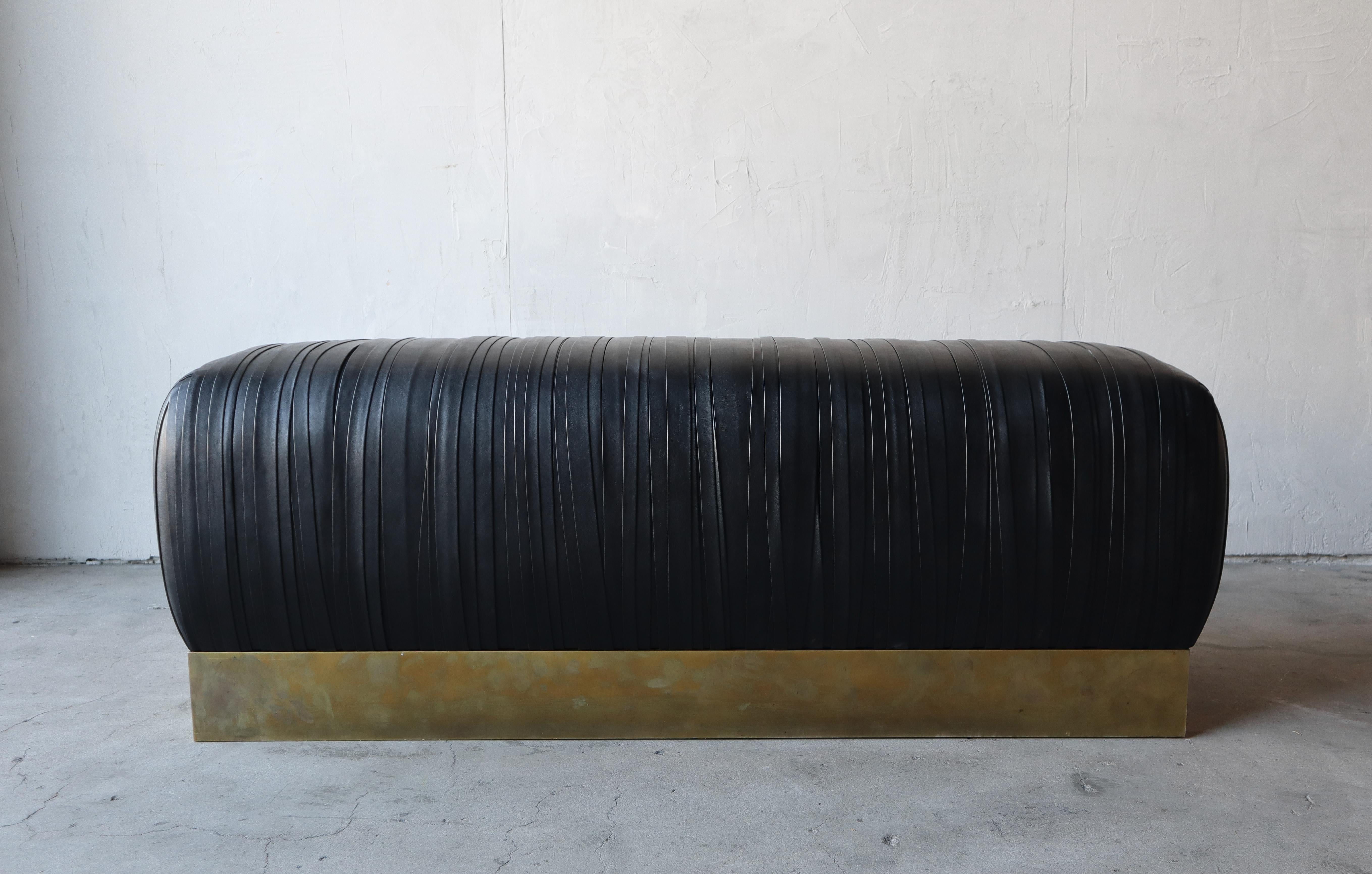 Stylish and substantial strapped black leather and brass plinth benches (2 available}. The benches are beautiful and would add so much class to any space. They are perfect almost anywhere, entry, foot of a bed or as additional seating in any room,