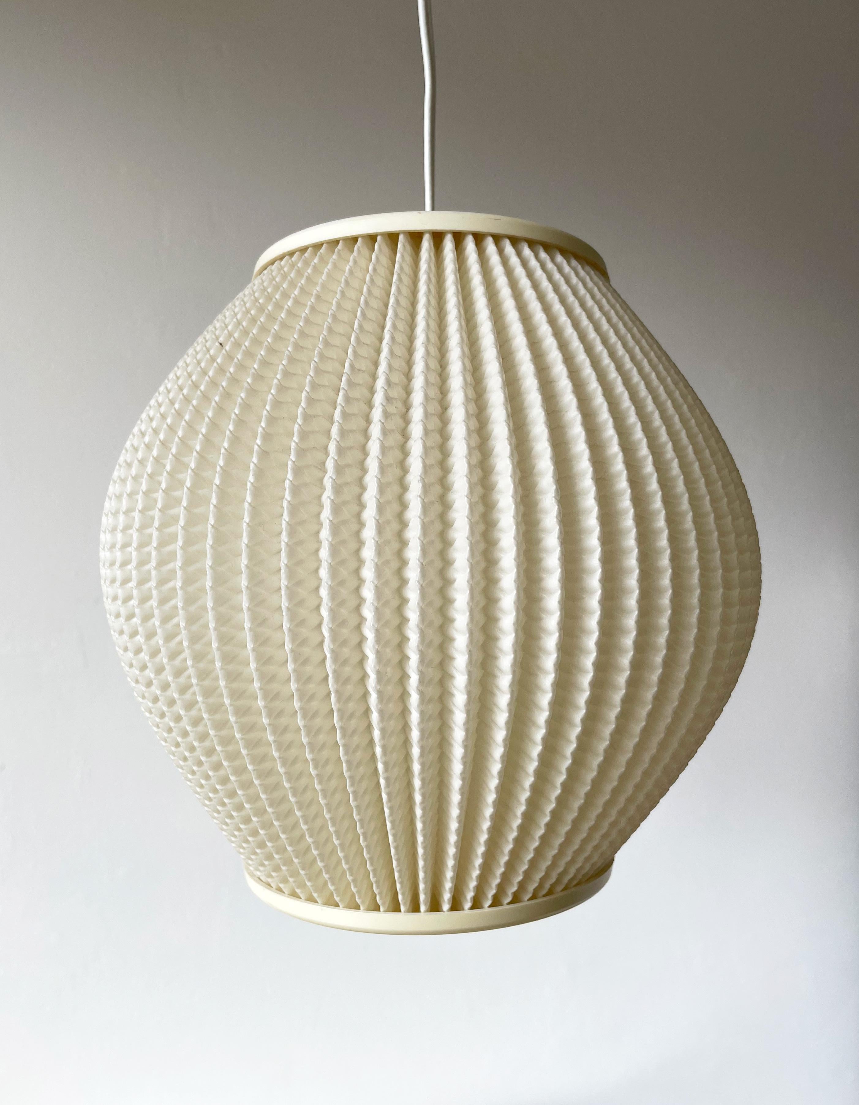Danish Mid-Century Modern pleated acrylic pendant in a cream white color with cream top and bottom. Designed by Lars Eiler Schiøler in 1960 for Hoyrup light. Model 