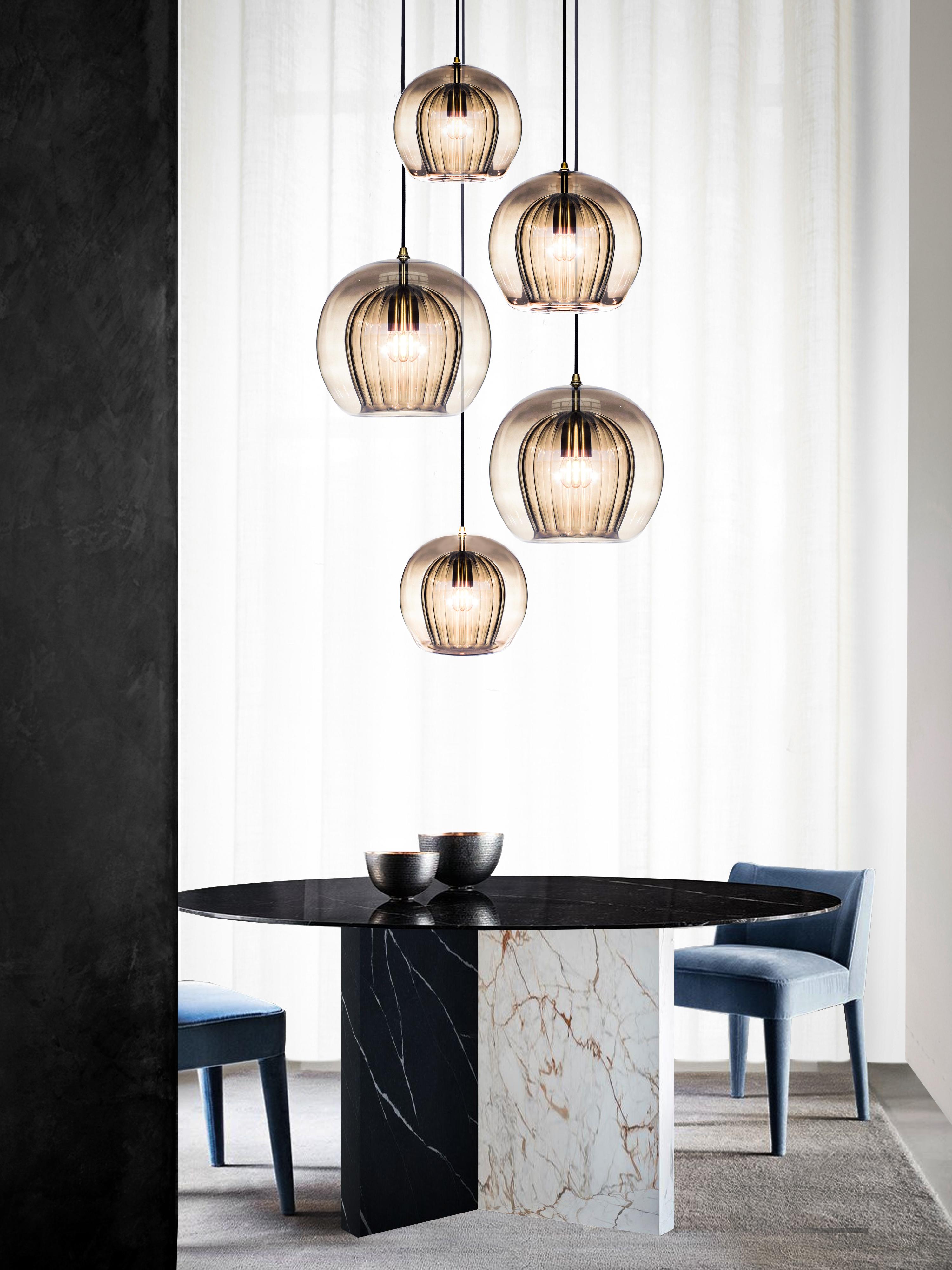 Our debut lighting collection comprising ceiling pendants, a side light and a floor standing lamp.

Handmade in Bohemia and London the collection draws upon our love for Czech artisan glass work and British engineered detailing.

Designed with