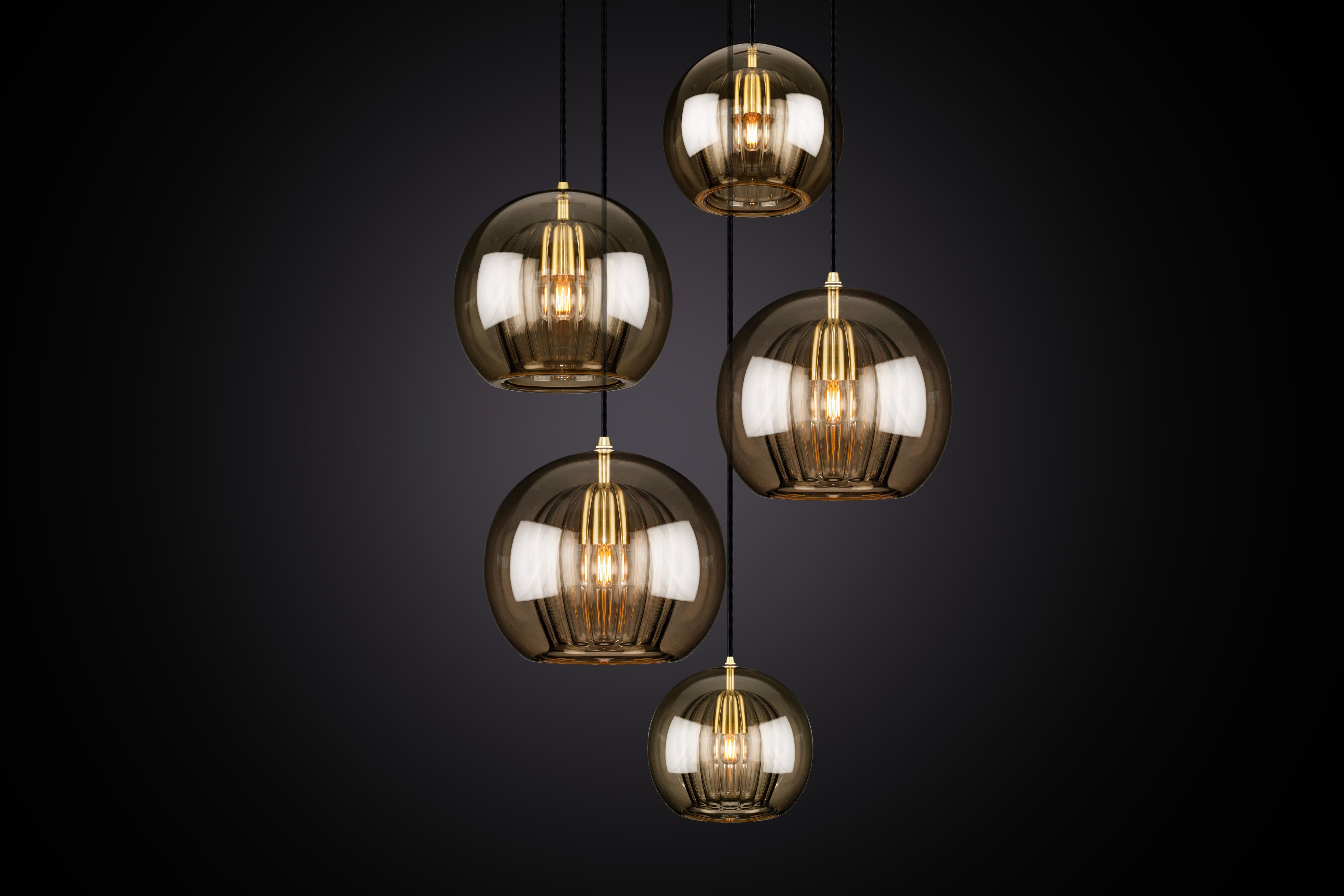 Our debut lighting collection comprising ceiling pendants, a side light and a floor standing lamp.

Handmade in Bohemia and London the collection draws upon our love for Czech artisan glass work and British engineered detailing.

Designed with