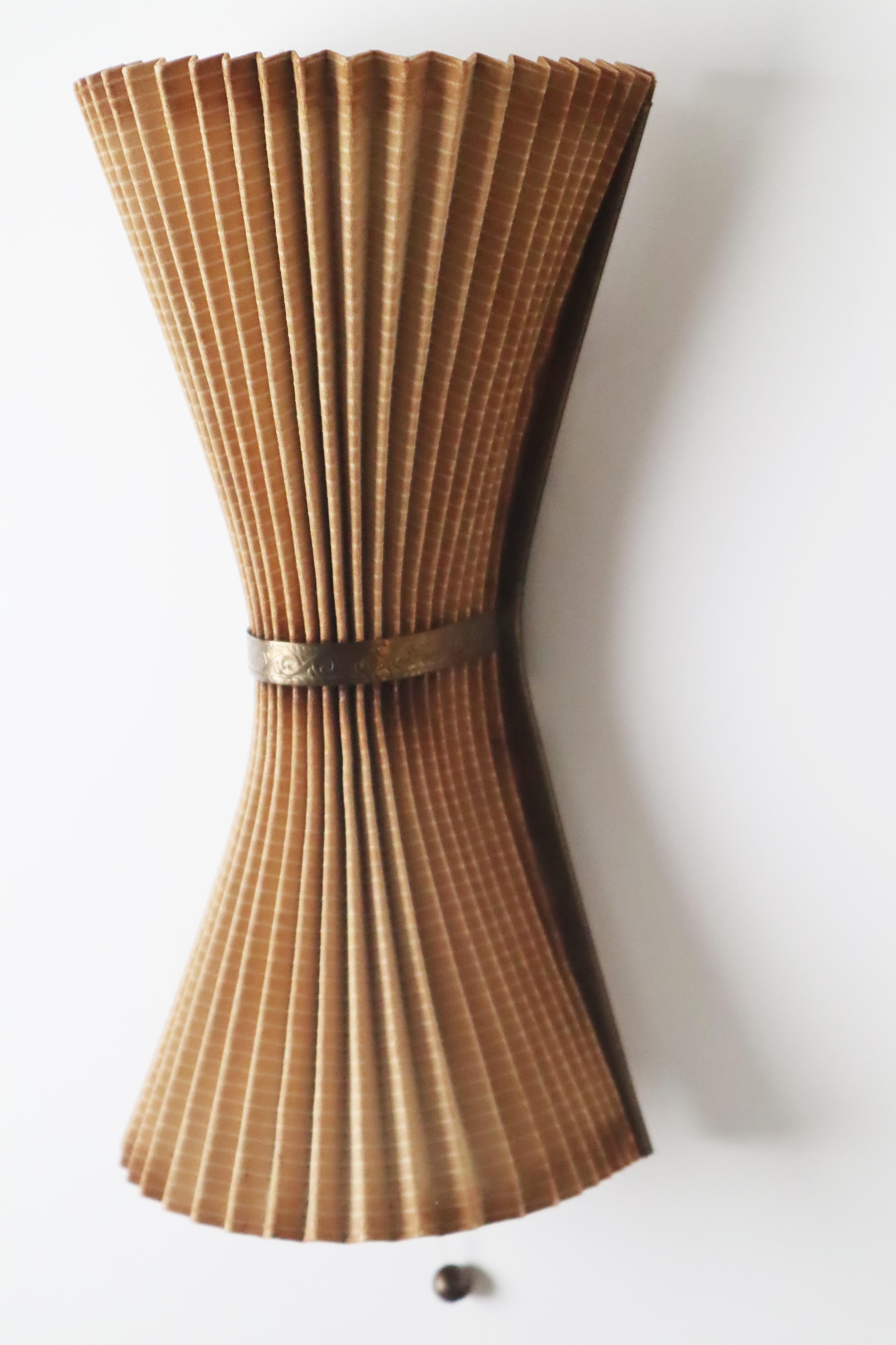 These rare pleated wall lights are really something special. The conical construction combined with the beautiful folding technique make these wall lights an absolutely rare design object for lovers. Considering the sensitive material used to make