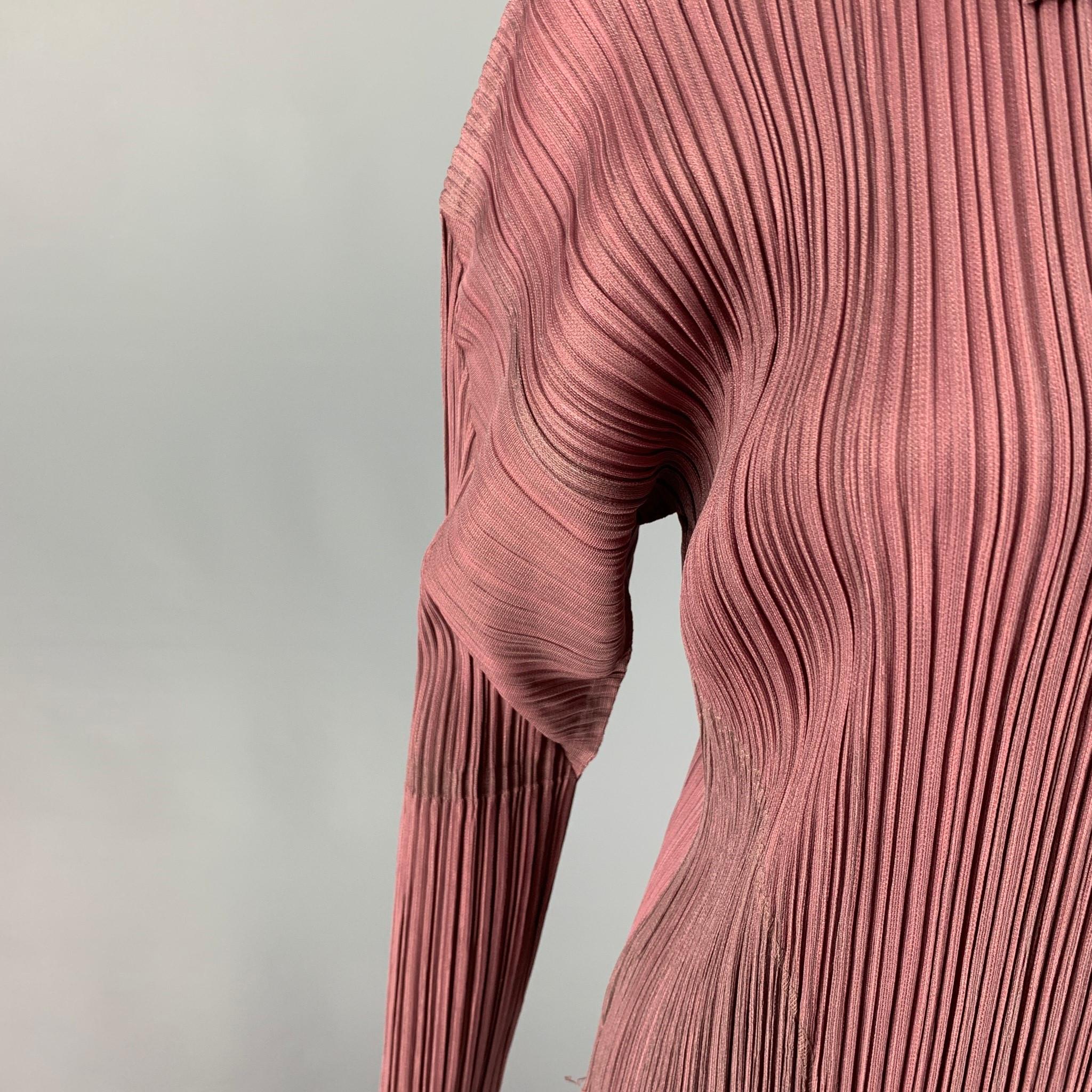 PLEATS PLEASE by ISSEY MIYAKE top comes in a mauve material featuring signature pleated design, spread collar, structured sleeves, and a full zip up closure. 

Excellent Pre-Owned Condition.
Marked: JP 2

Measurements:

Shoulder: 22 in.
Bust: 38