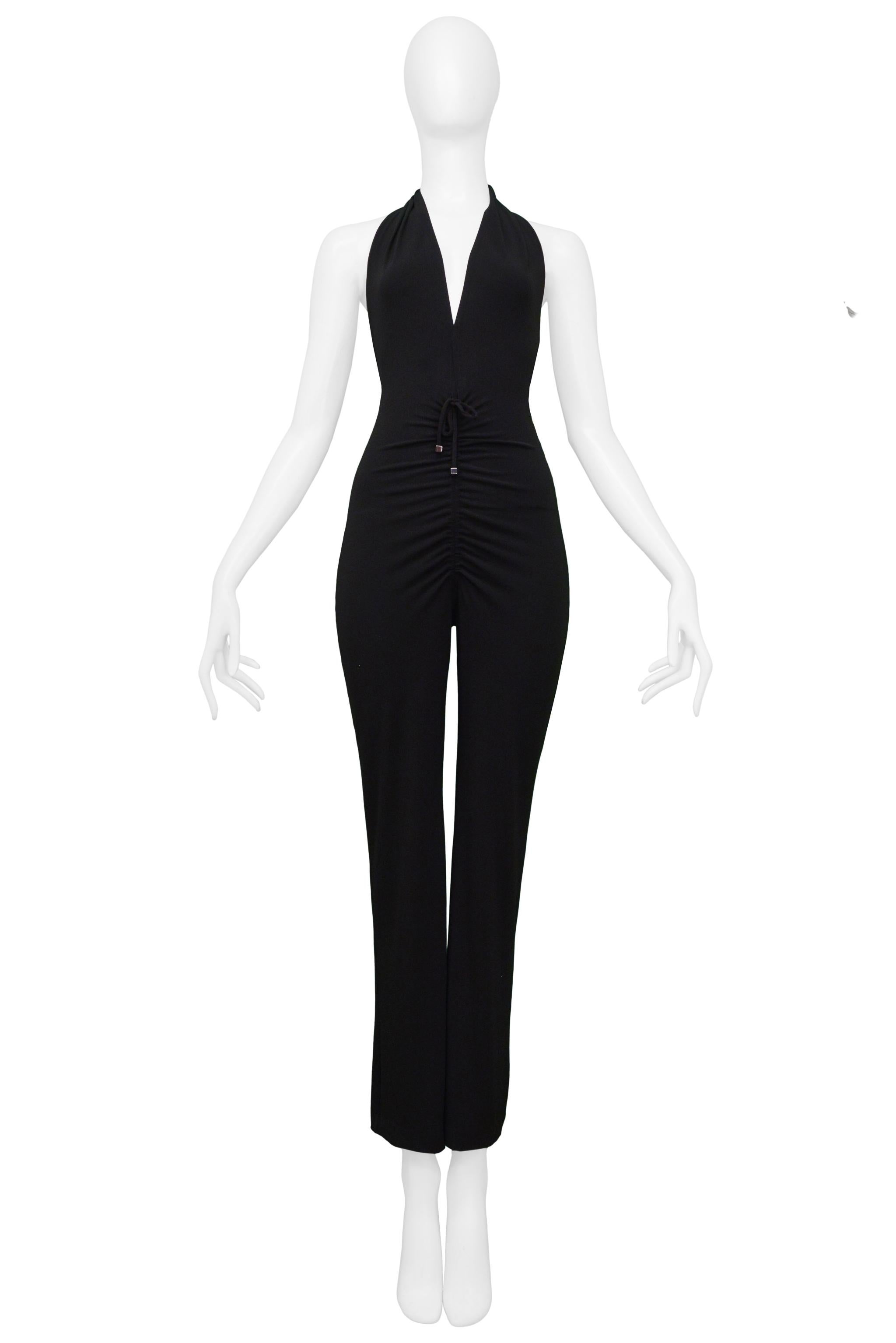 Resurrection Vintage is excited to present a vintage Plein Sud black jersey disco jumpsuit featuring a halter top, deep V neckline, exposed back, drawstring with chrome hardware, and gathered front. 

Plein Sud 
Size: 38
Acetate, Polyester, Spandex