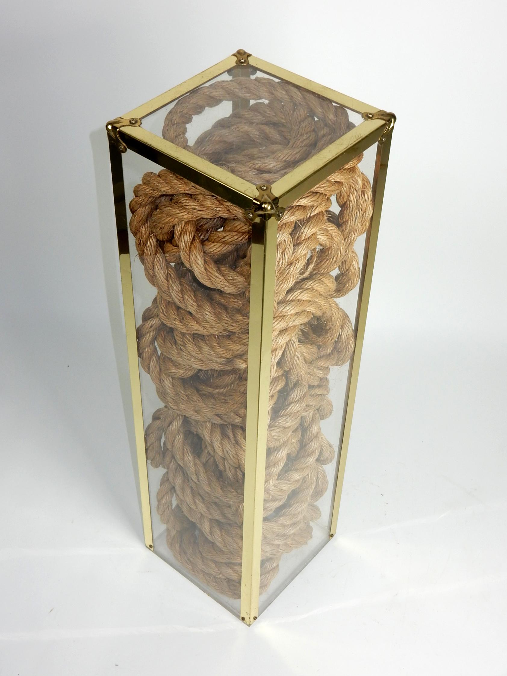 Hemp rope encased in plexiglas pedestal circa 1960's.
Brass trimmed, sealed base. Not marked by artist.
32-1/4 inch tall with a center top plexi surface measuring 7-1/4 inch square.

  