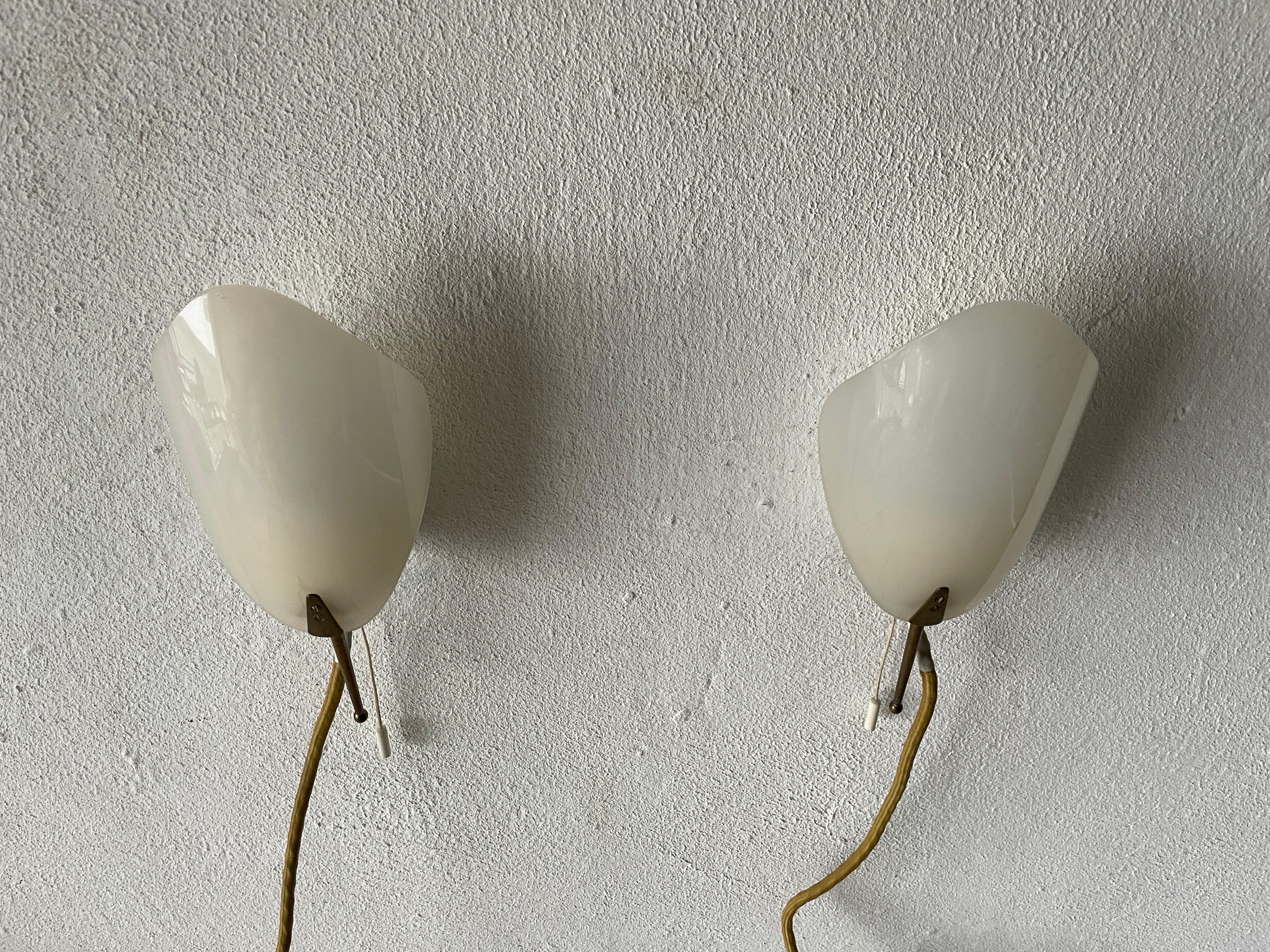 Mid Centursy Modern Plexiglass and Brass Leaf shaped Pair of Sconces, 1950s, Germany

Very elegant and Minimalist wall lamps
Lamp is in very good condition.

These lamps works with E14 standard light bulbs. 
Wired and suitable to use in all