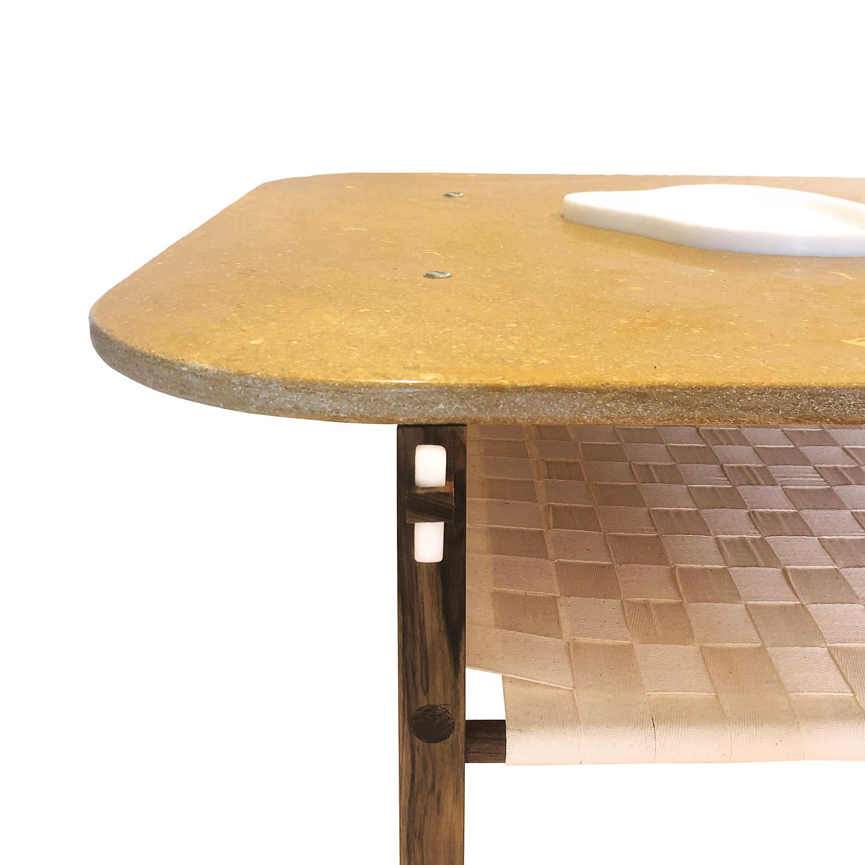 A marble and wood coffee table

With a curved yellow Jaisalmer marble top supporting a mobile embedded marble tray.
Supported with a square walnut frame joined to the four with keys made of white Makrana marble.
With a lower tier woven with