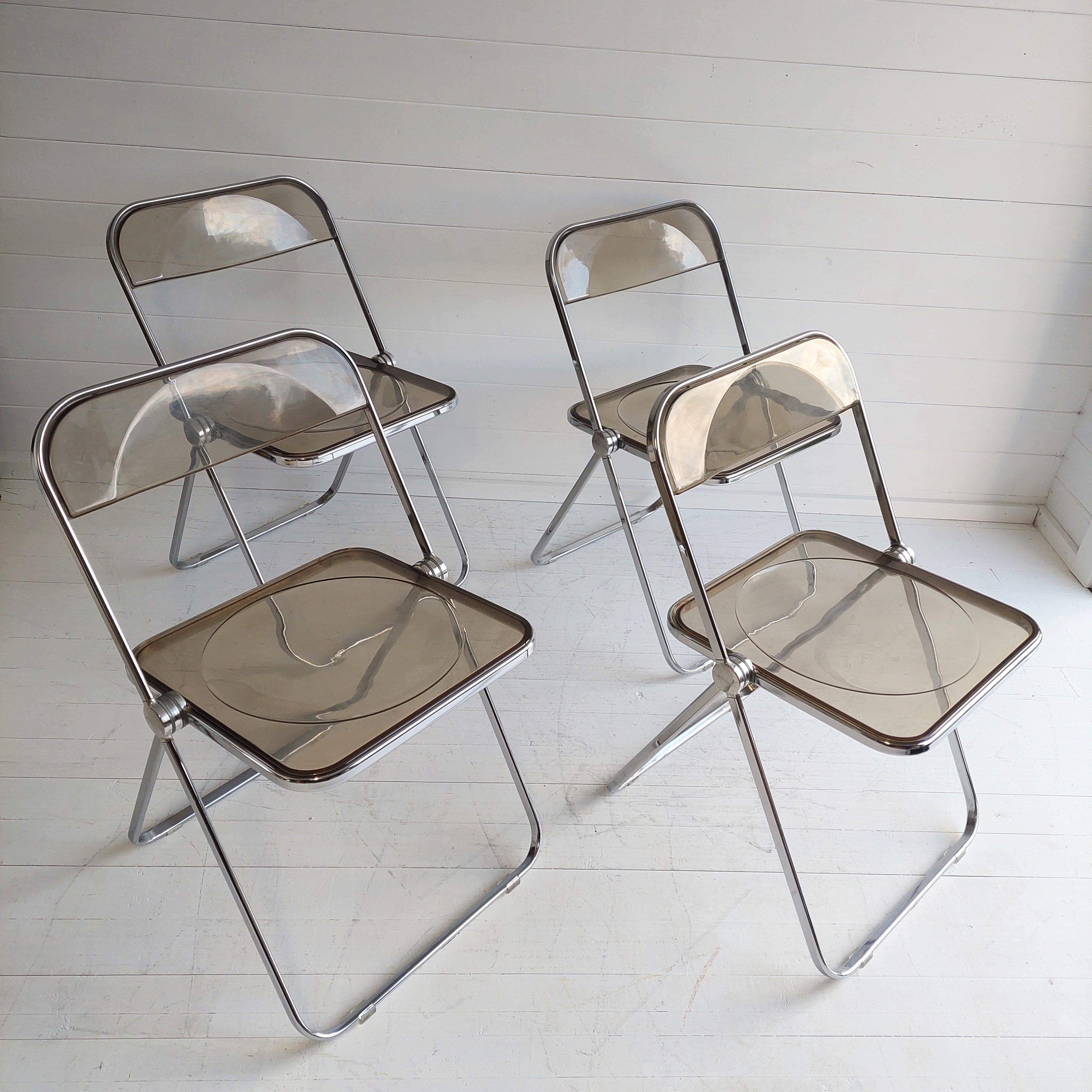 Iconic foldable chair. Designed by Giancarlo Piretti. Made from hard plastic and a chromed steel frame.
They are in very good condition and made of lucite and chrome and the lucite is a lovely mid century smoked colour.
The Plia folding chair is a