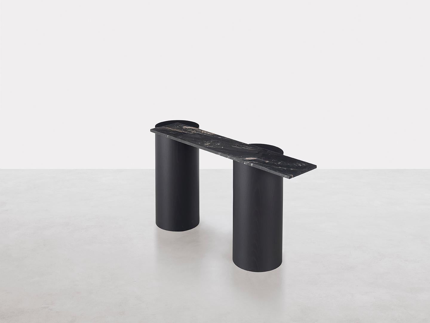 The column legs of this console table have the same relevance as ancient temple legs.
The lofty reference is contrasted by the playful play of the cantilevered top: historic in material, marble,
and contemporary in the balance that suggests