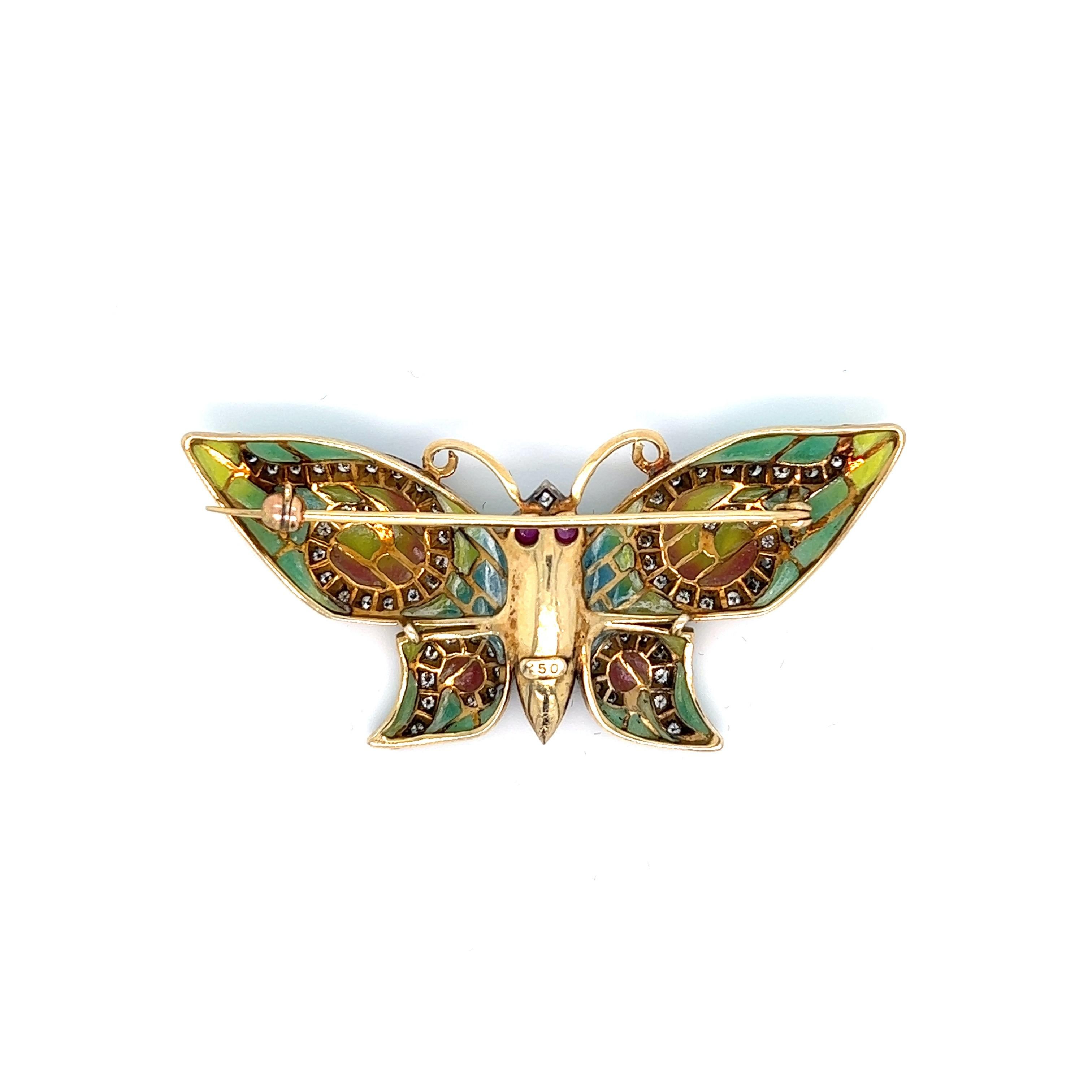 Plique-á-jour butterfly brooch; marked 750

Round-cut diamonds of approximately 1 carat, cabochon ruby eyes of approximately 0.80 carat, 18 karat yellow gold

Size: width 2.13 inches, length 1 inch
Total weight: 10.3 grams 