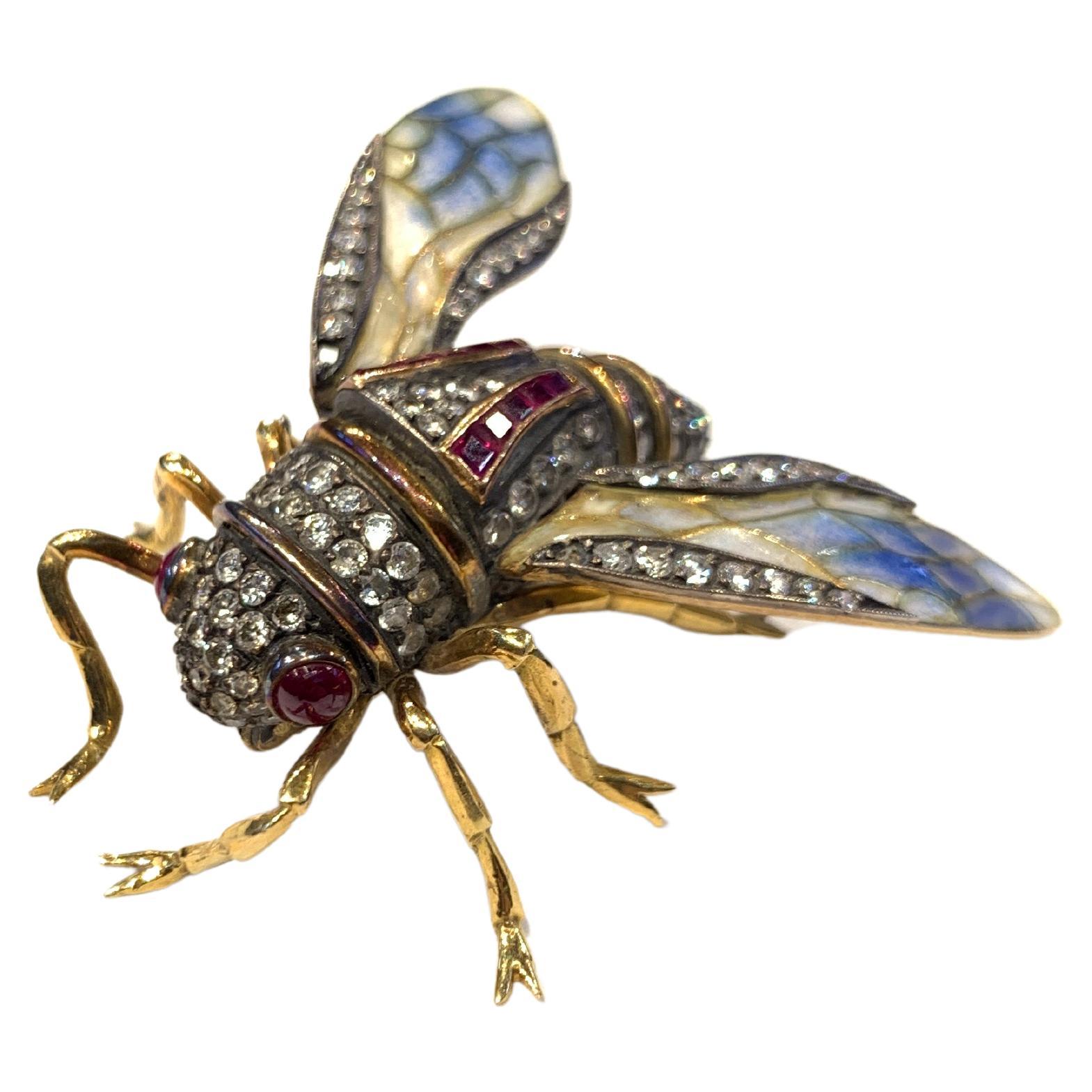 Plique a Jour Cicada Brooch

A 22 karat gold brooch in the design of a cicada set with cabochon ruby eyes, 10 square cut rubies, round cut diamonds, and beautifully detailed 