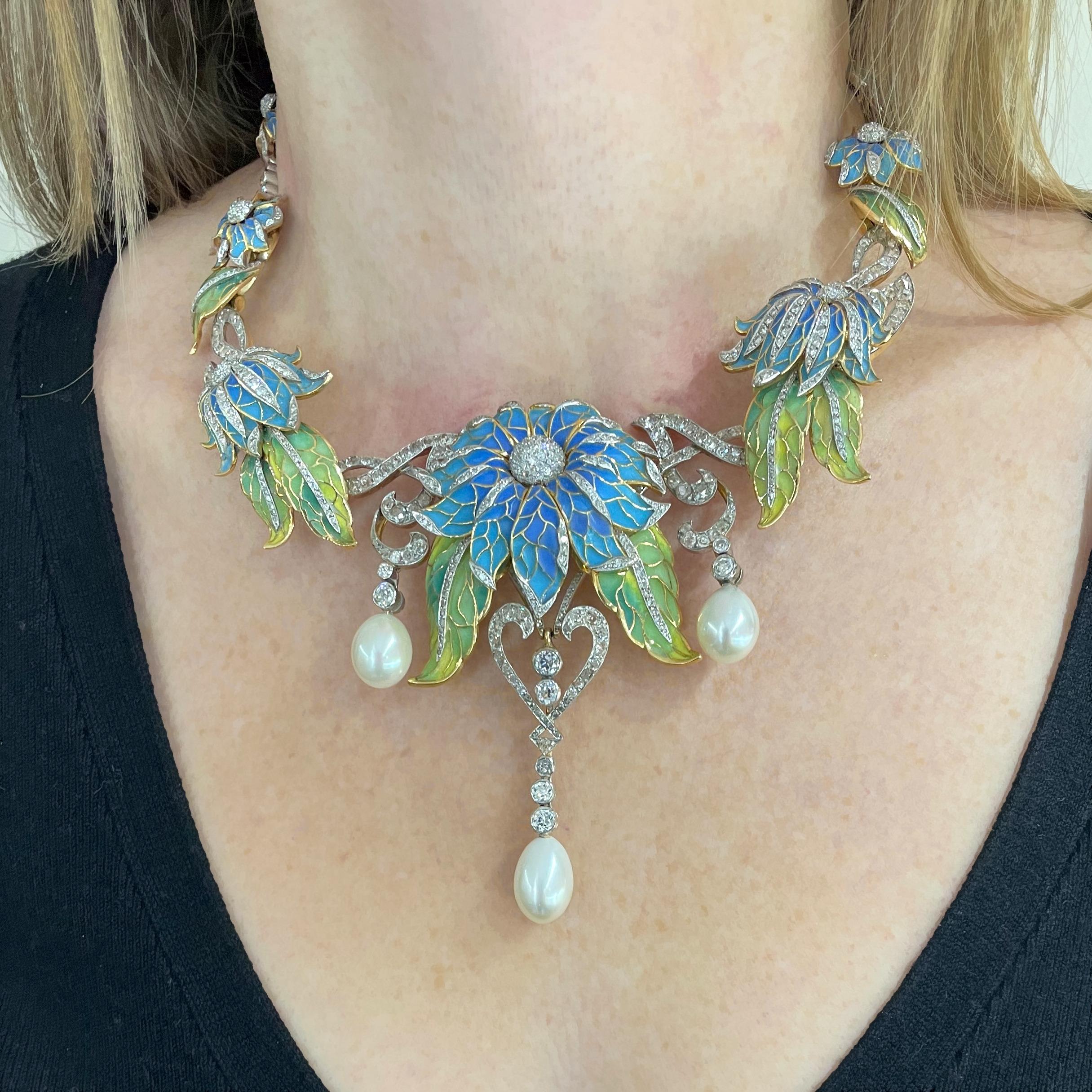 A Moira Collection, plique-à-jour enamel flower necklace, with sky blue plique-à-jour enamel flowers, and green plique-à-jour leaves, with old-cut and eight-cut diamonds and three large cultured drop pearls at the front, mounted in silver-upon-gold.