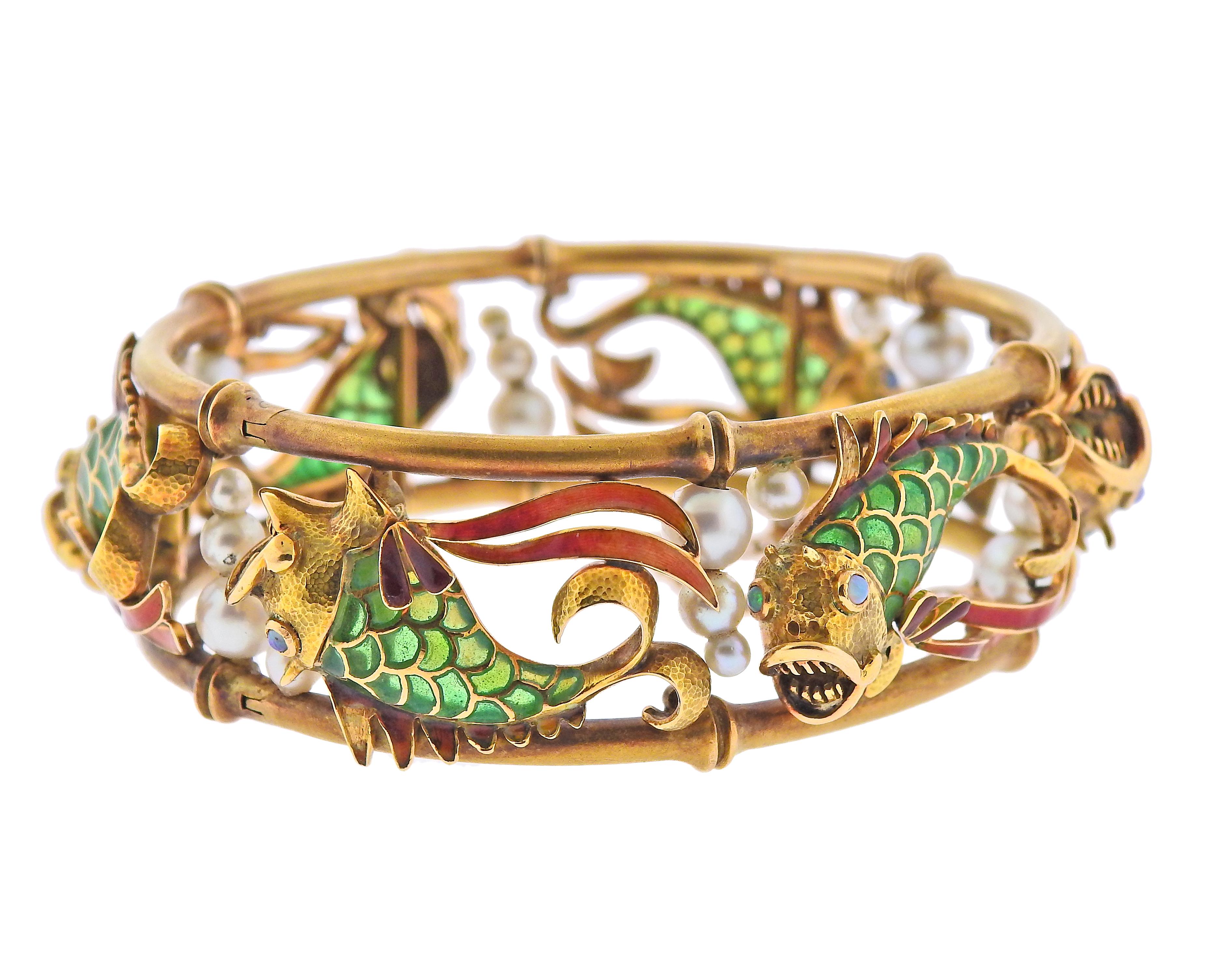 18k gold bangle bracelet, set with pearls, opals and Plique-a-Jour enamel, featuring fish.  Bracelet will fit approx. 7