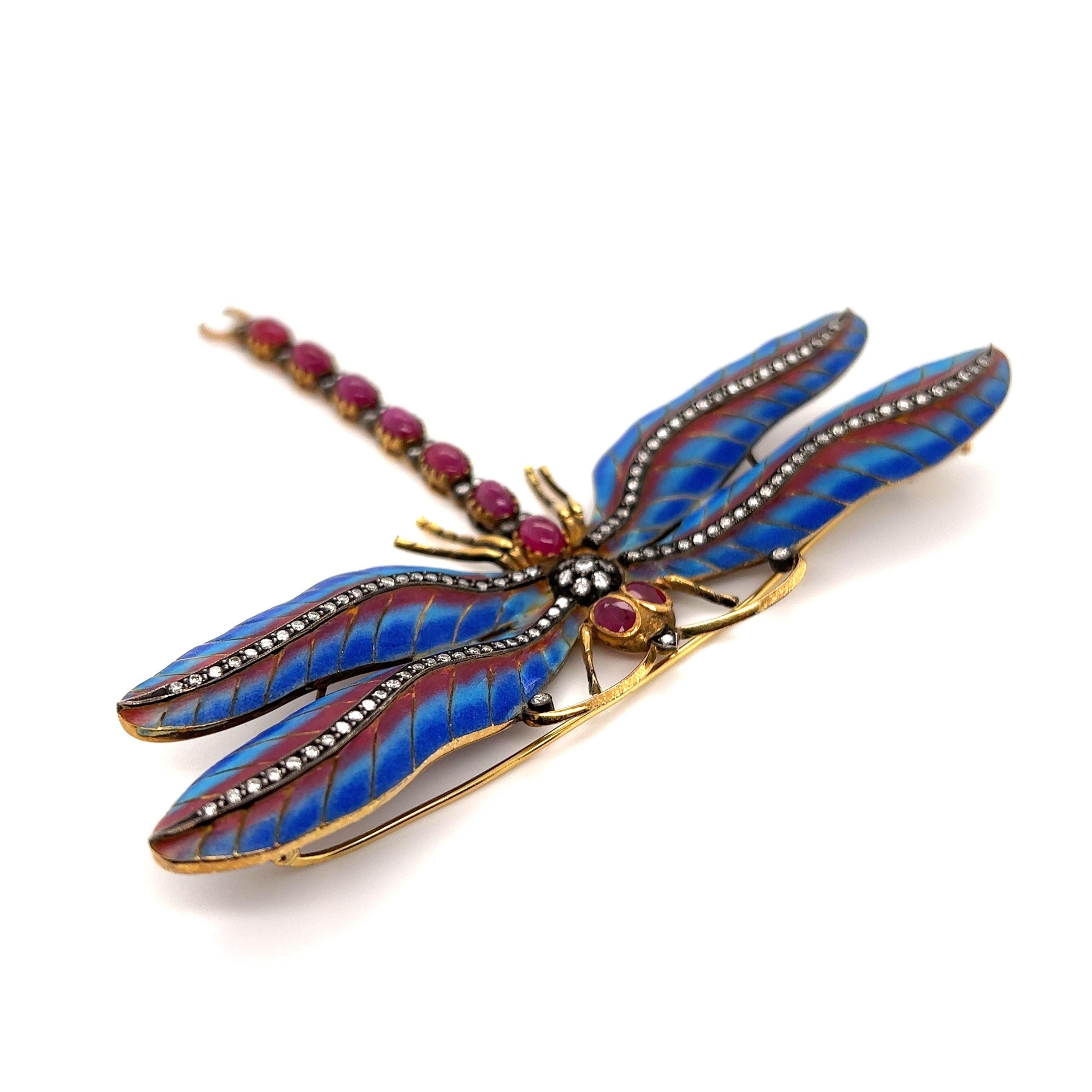 Simply Fabulous! Plique-à-Jour Dragonfly Brooch with Blue and Red enamel wings, Hand set with Rubies, approx. 3.5tcw and Diamonds, approx. 1.16tcw.  Hand crafted in 18 Karat Yellow Gold. Approx. size: 4” tall. This pin is in excellent vintage