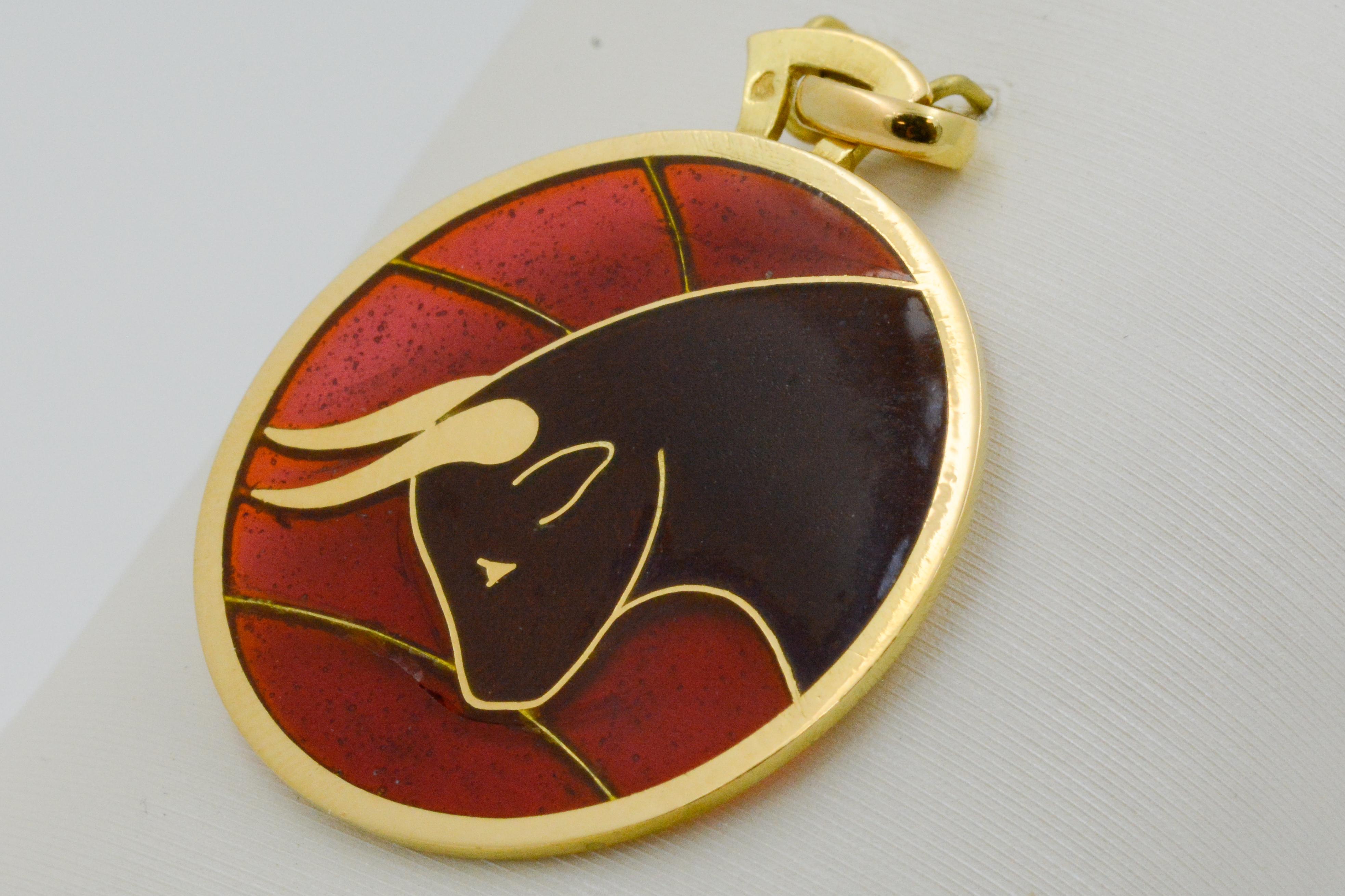 In deep red and brown, accented with 18 karat yellow gold, this Plique a Jour Taurus pendant is lightweight and captivating. The intricate details captured by a master craftsman in the Plique a Jour enameled glass art is showcased in this delicate