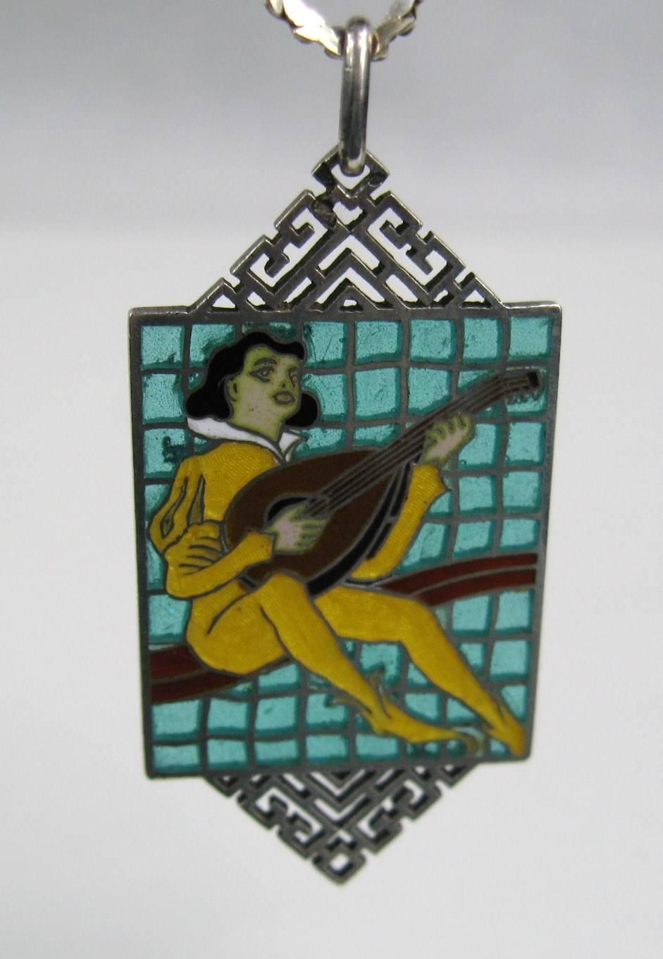  The image on this wonderful pendant is a troubador, and he is playing a lute. Troubador's have other names, depending on their region, such as trouvere or jongleur. Most people are more familiar with the term troubador, who roamed about the