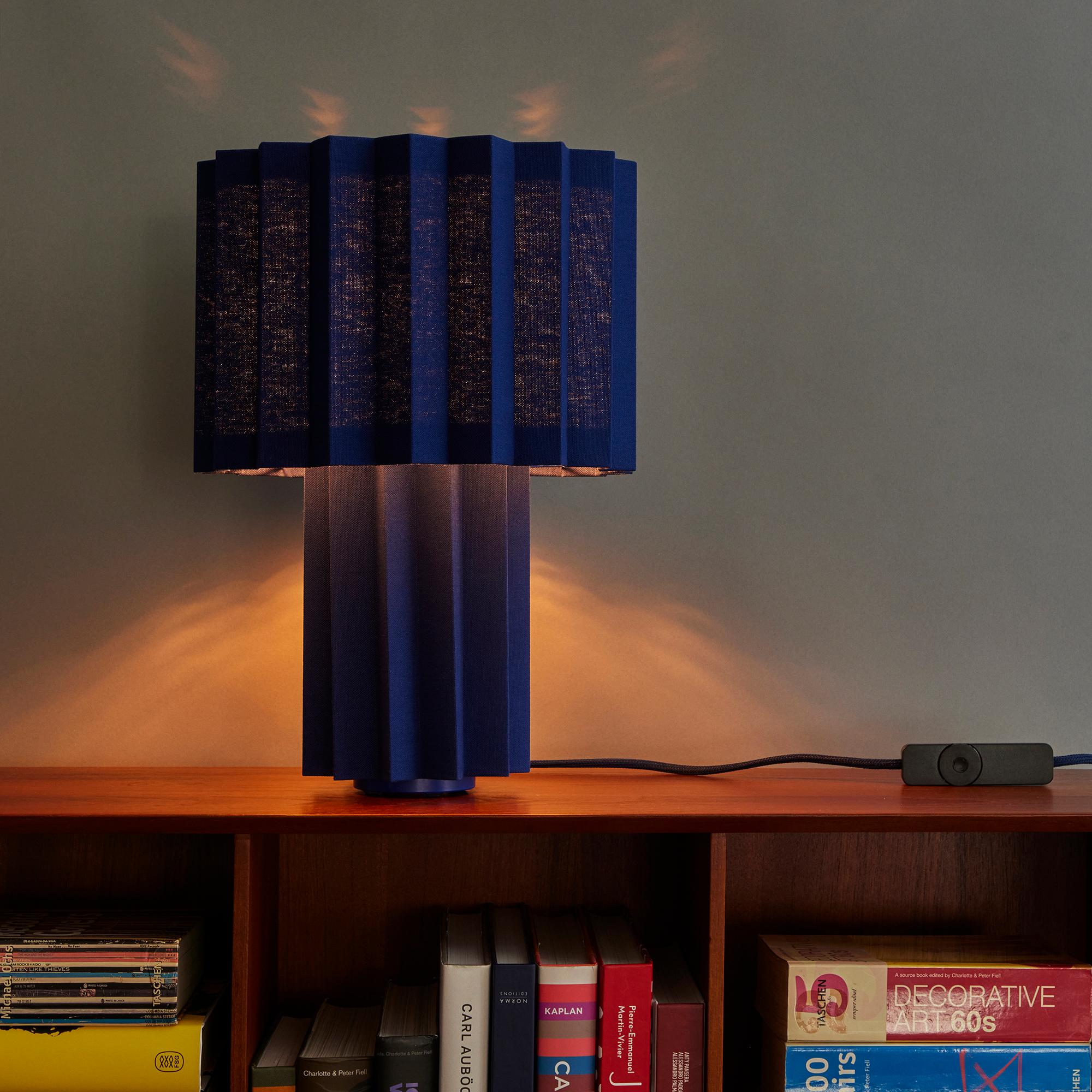 'Plissé Blue Edition' pleated textile table lamp by Folkform for Örsjö.

This unique table lamp was awarded “Lighting of the Year 2022” by Residence Magazine Sweden, who called it “a sophisticated jewel of light that brings the somewhat neglected