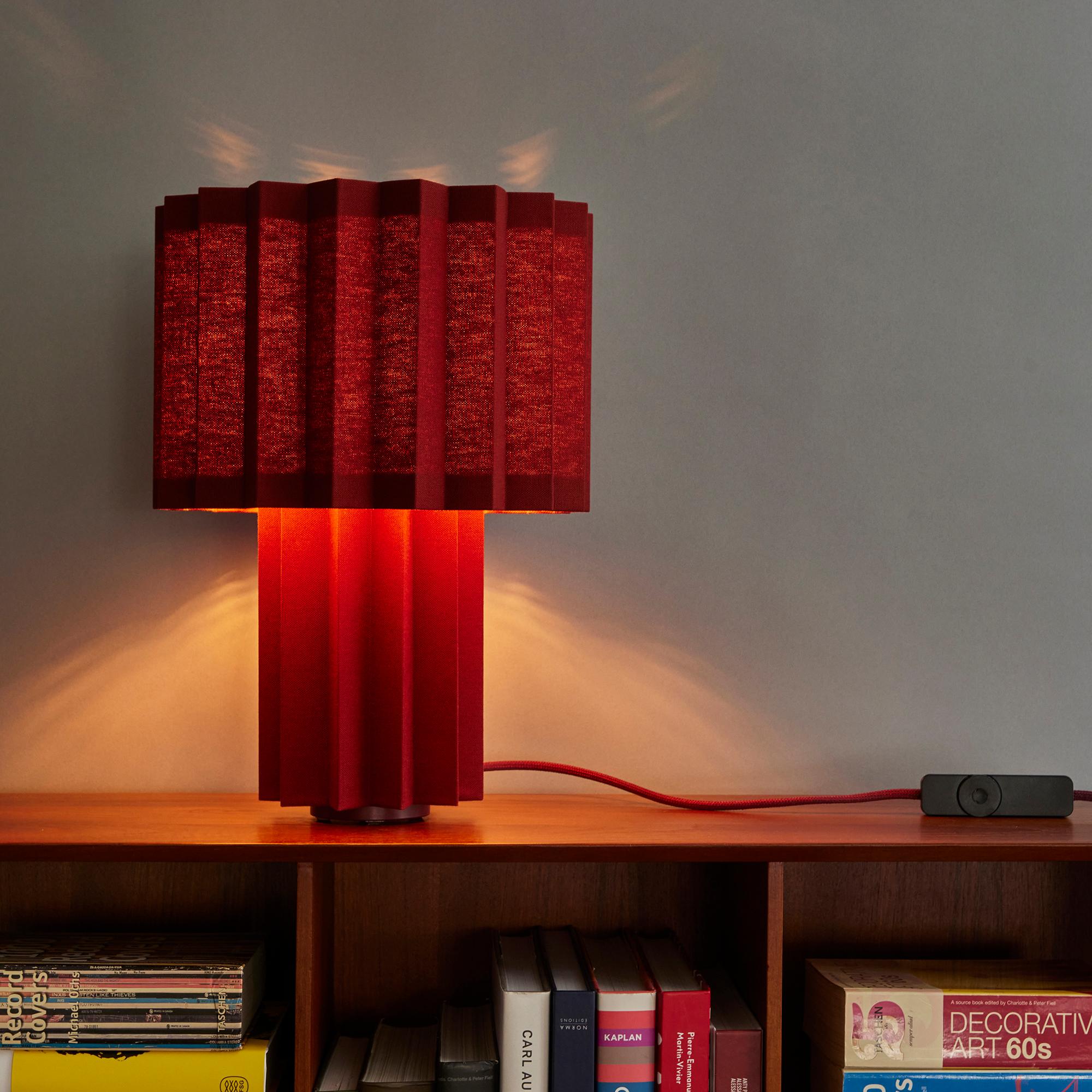 'Plissé Burgundy Edition' pleated textile table lamp by Folkform for Örsjö.

This unique table lamp was awarded “Lighting of the Year 2022” by Residence Magazine Sweden, who called it “a sophisticated jewel of light that brings the somewhat