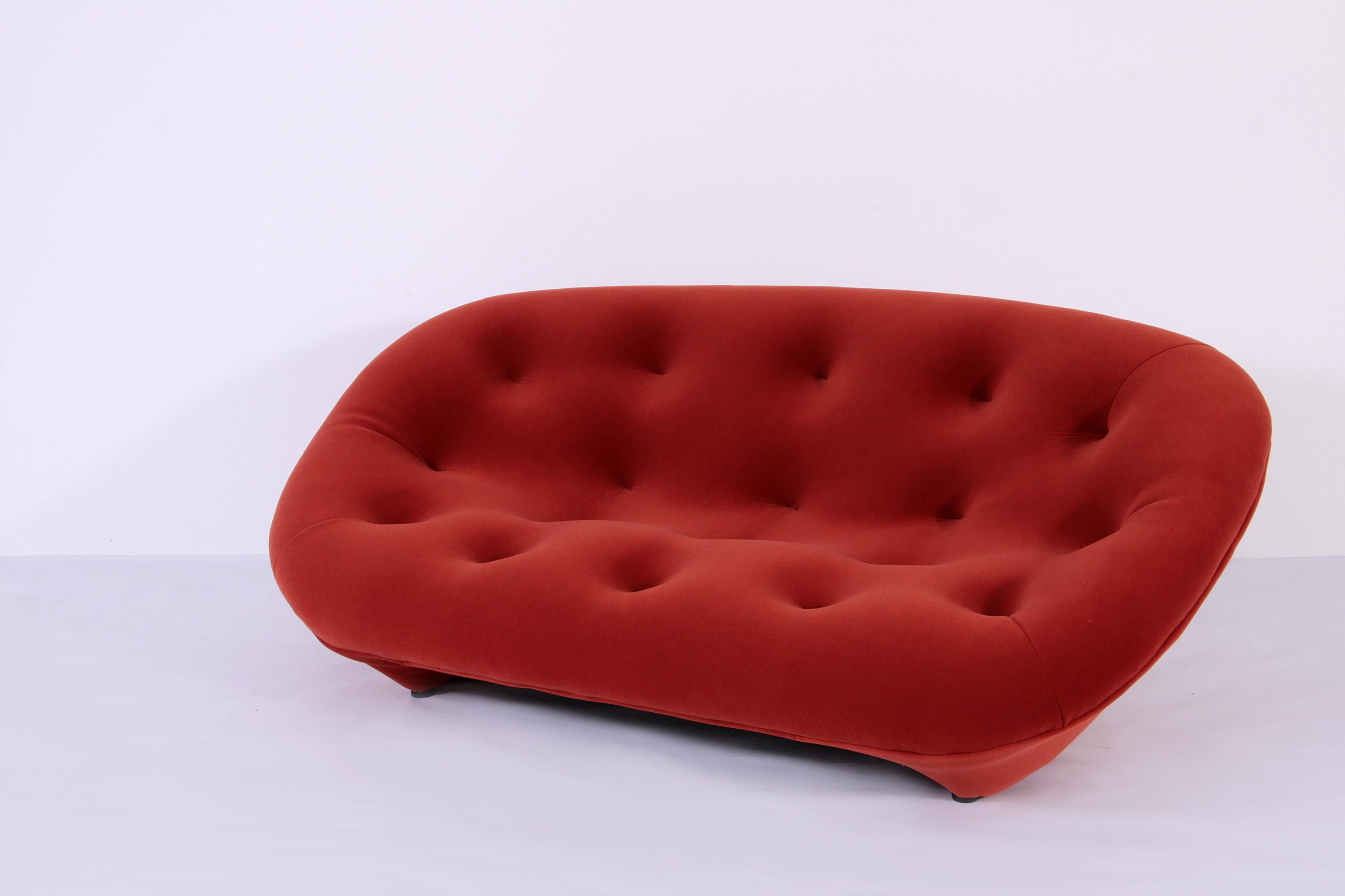 The Ploum Sofa, designed by Ronan & Erwan Bouroullec, is a modern icon reimagined in luxurious rusty orange velvet. With its soft, cocooning curves and seamless, low-slung design, it combines avant-garde aesthetics with exceptional comfort. Perfect