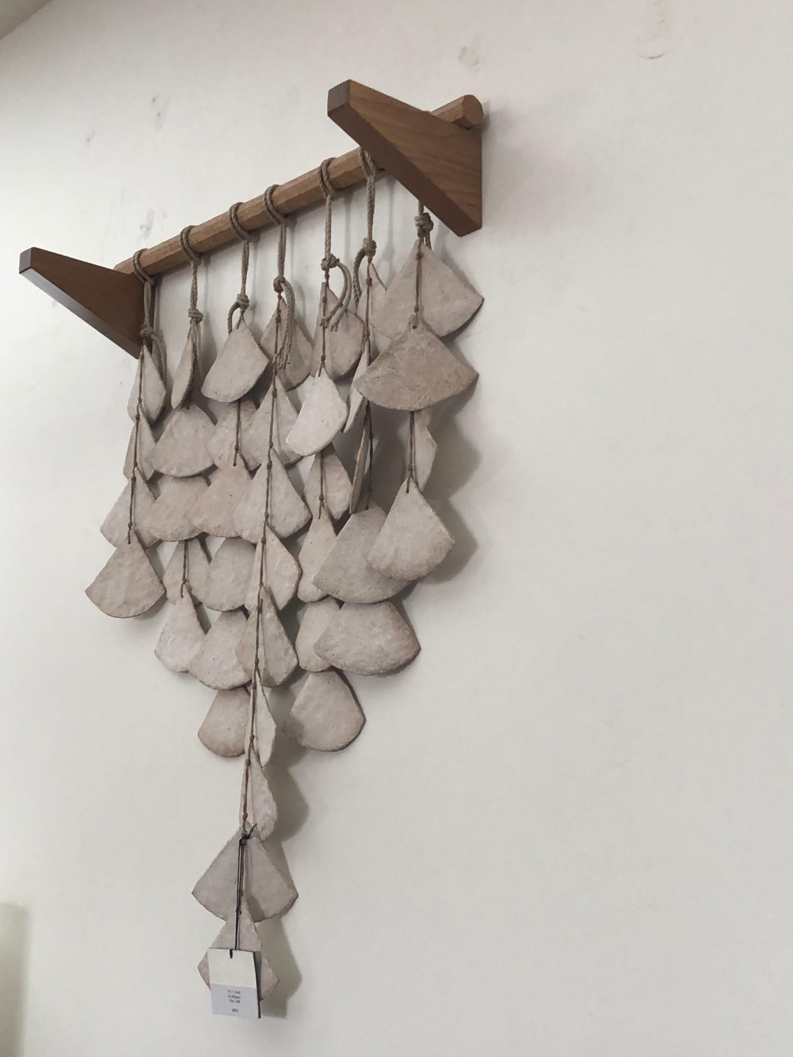 PLT 7 shell by MQuan 

Includes ceramic wall hanging, wooden dowel, and two wedge wall hooks