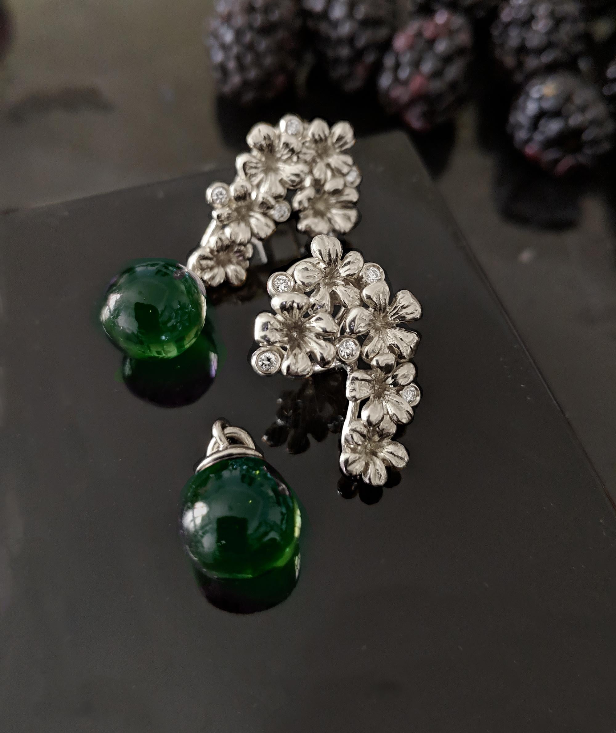 These Plum Blossom cocktail clip-on earrings with green cabochon drops of amber are made of sterling silver and are encrusted with 10 round diamonds (0,3 carats). This piece is from a limited edition collection of contemporary jewelry and was