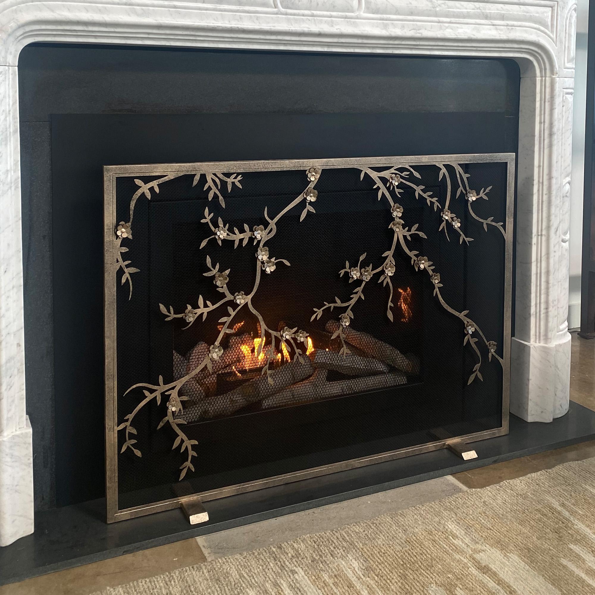 Introducing the Plum Blossom fireplace screen – an eye-catching design that combines the beauty of nature with the warmth of the hearth. Each made to order screen combines silhouetted branches with layered petals to create a playful and delicate