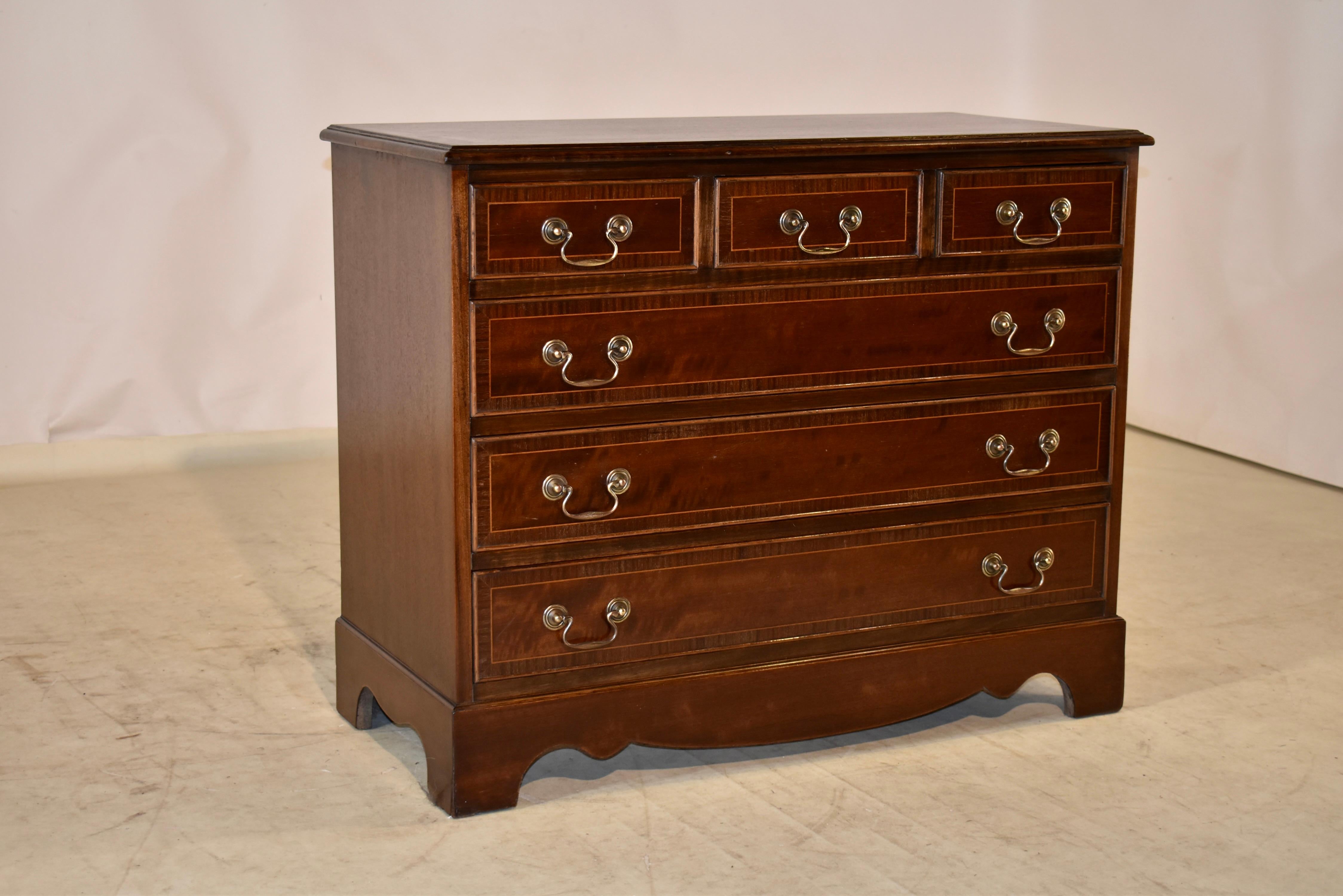 Circa 1950 mahogany chest of drawers from England. The case is veneered in plum pudding mahogany, which gives this chest a stunning profile from any angle in a room. The top is banded in mahogany and satinwood, and has a beveled edge. The sides are
