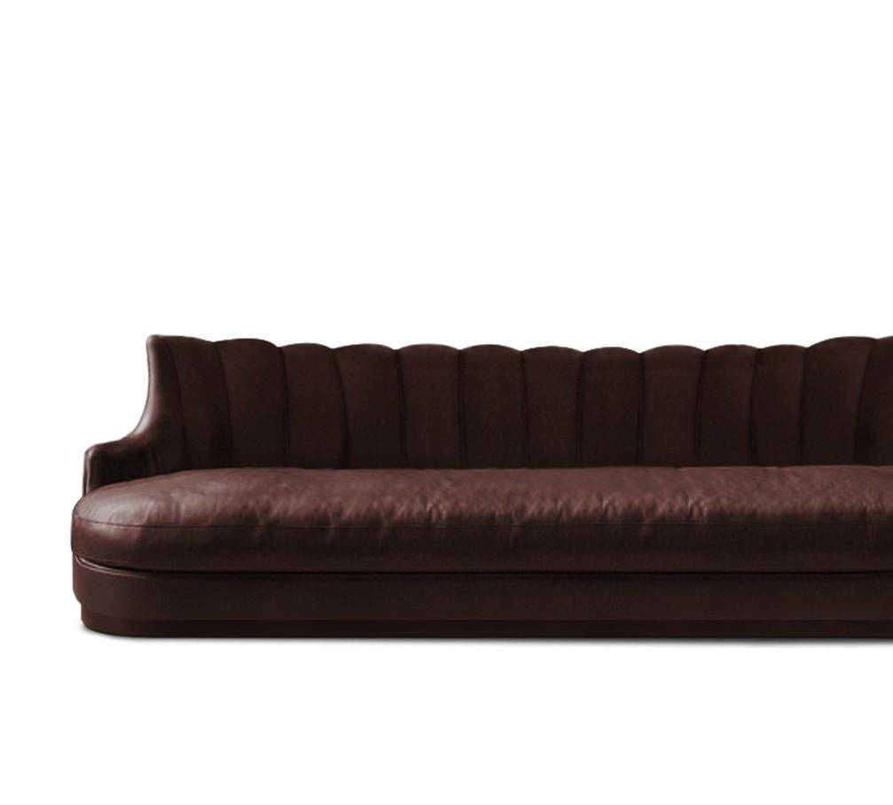 PLUM is a throwback to the past with a contemporary touch. With matte aged brass legs, this fully upholstered sofa celebrates luxury and opulence highlighted by the synthetic leather that surrounds it. Place it in a modern living room and this