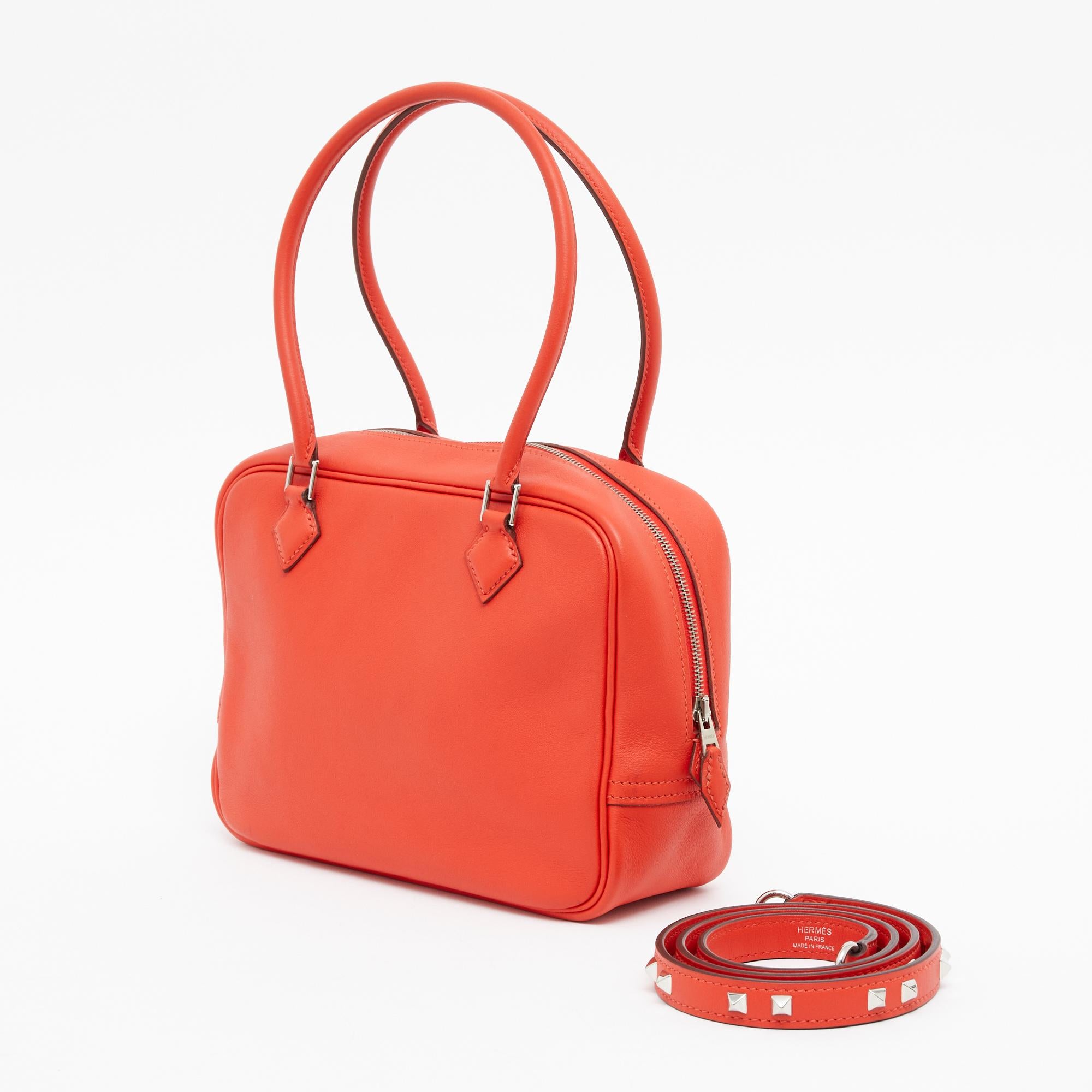 Hermès bag model Plume TPM format in Swift leather color Capucine, i.e. a very bright red orange, silver-colored metalwork, interior in coordinated leather and shoulder strap Mini Dog model in coordinated leather and metalwork (purchased in July