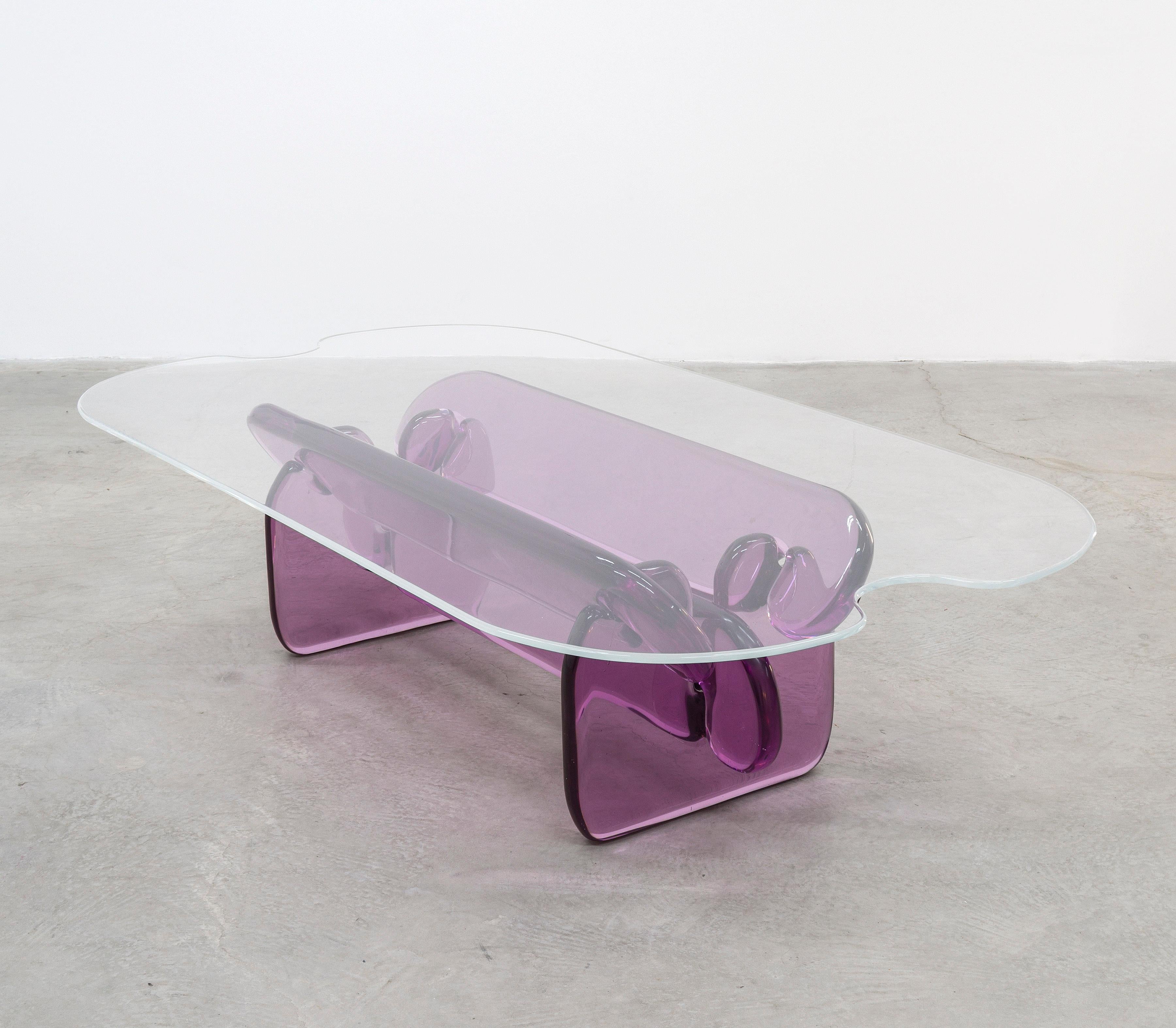 The Plump table is constructed of five, solid cast, resin parts that interlock to create the base for a clear acrylic top. The parts are rounded over and pillow-like to compliment its simple nature and childlike assembly. Resin was employed because