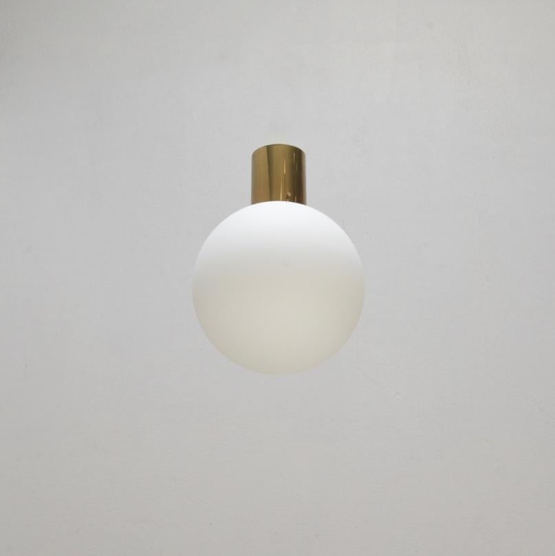 PLUnet globe ceiling flush mount fixture by Lumfardo Luminiaires. The PLUnet is a simple yet elegant Mid-Century Modern inspired design of a globe flush mount fixture in patinated brass and glass. Wired with a single E-26 medium based socket. Wired