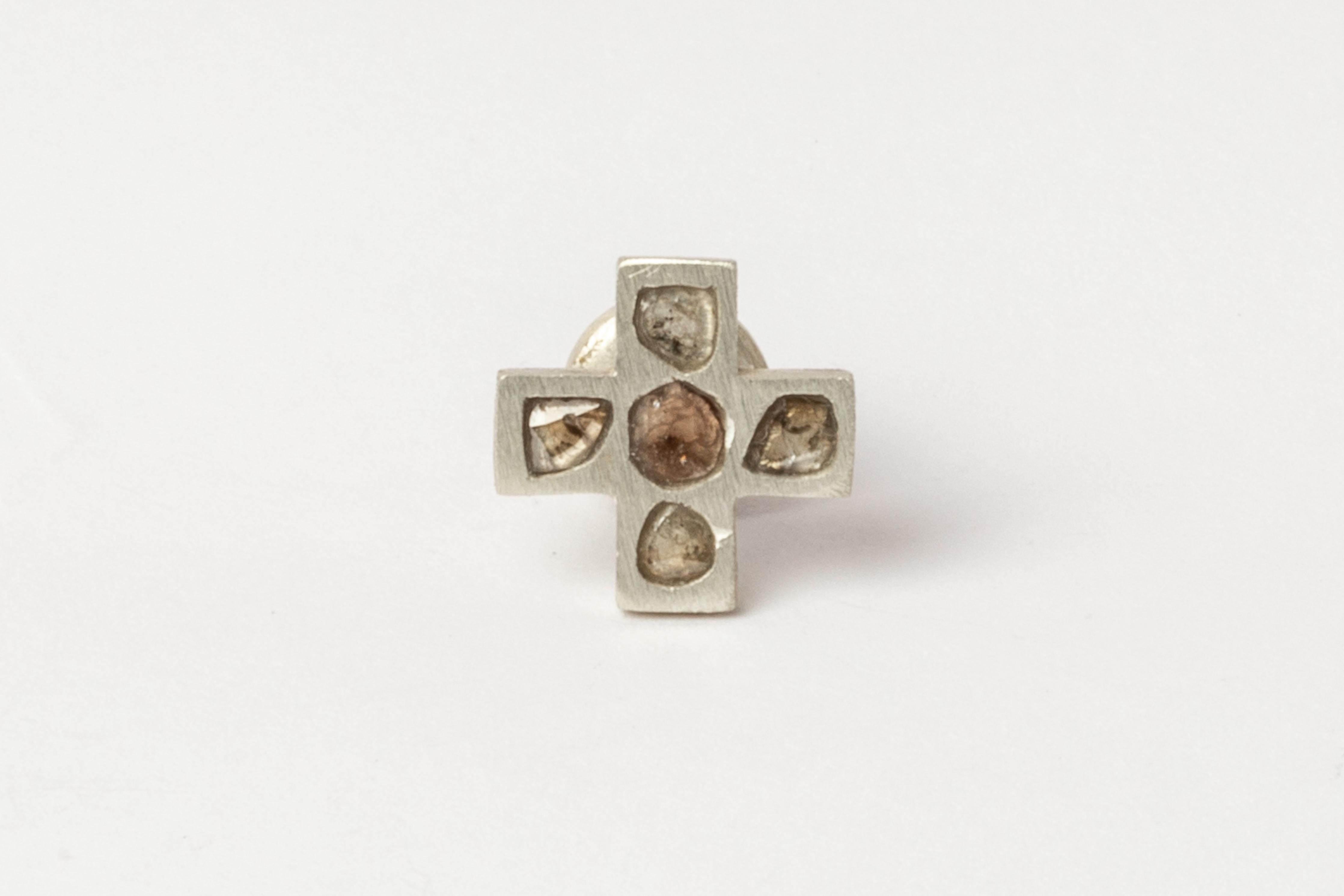 Plus earring in matte sterling silver and rough diamond. The stones used in this item are cuts of diamond material that are removed from a larger chunk of diamond as they are attempting to get to the perfect diamond in the center. Each stone