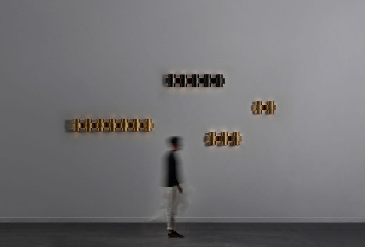 PLUS Series is a new range of appliqués by Paul Matter that feature a simple shape in singular and repetitive arrangements. A 3-Dimensional plus is formed out of a single tube of brass that is cut, bent and finished. The light source nestled within