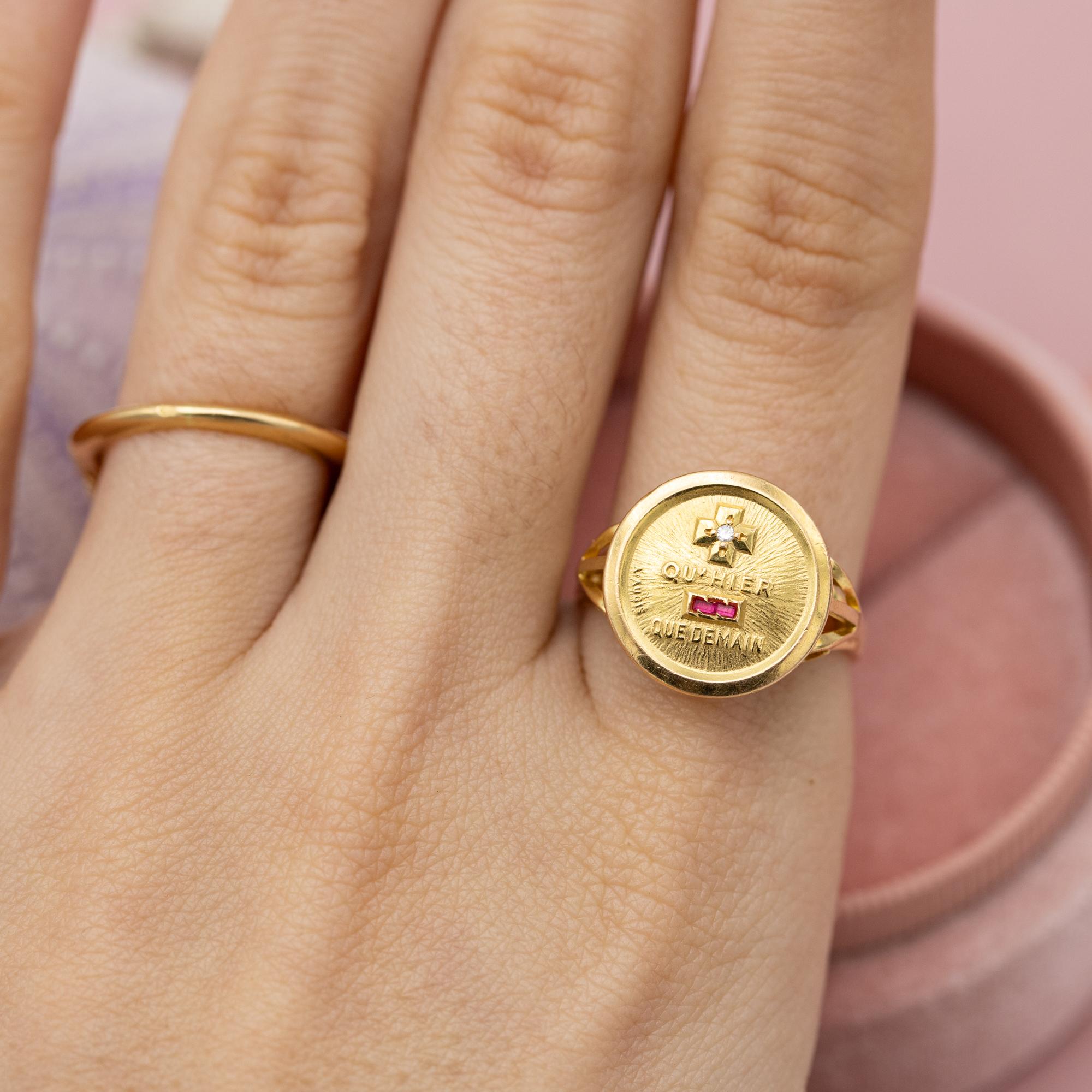 This lovely 18 karat Yellow gold ring holds the most beautiful and popular love medallion of all times. Plus qu'hier et moins que demain. This lovely medallion depicts a small cross and minus in the places of the words 'plus' and 'moins'. The cross